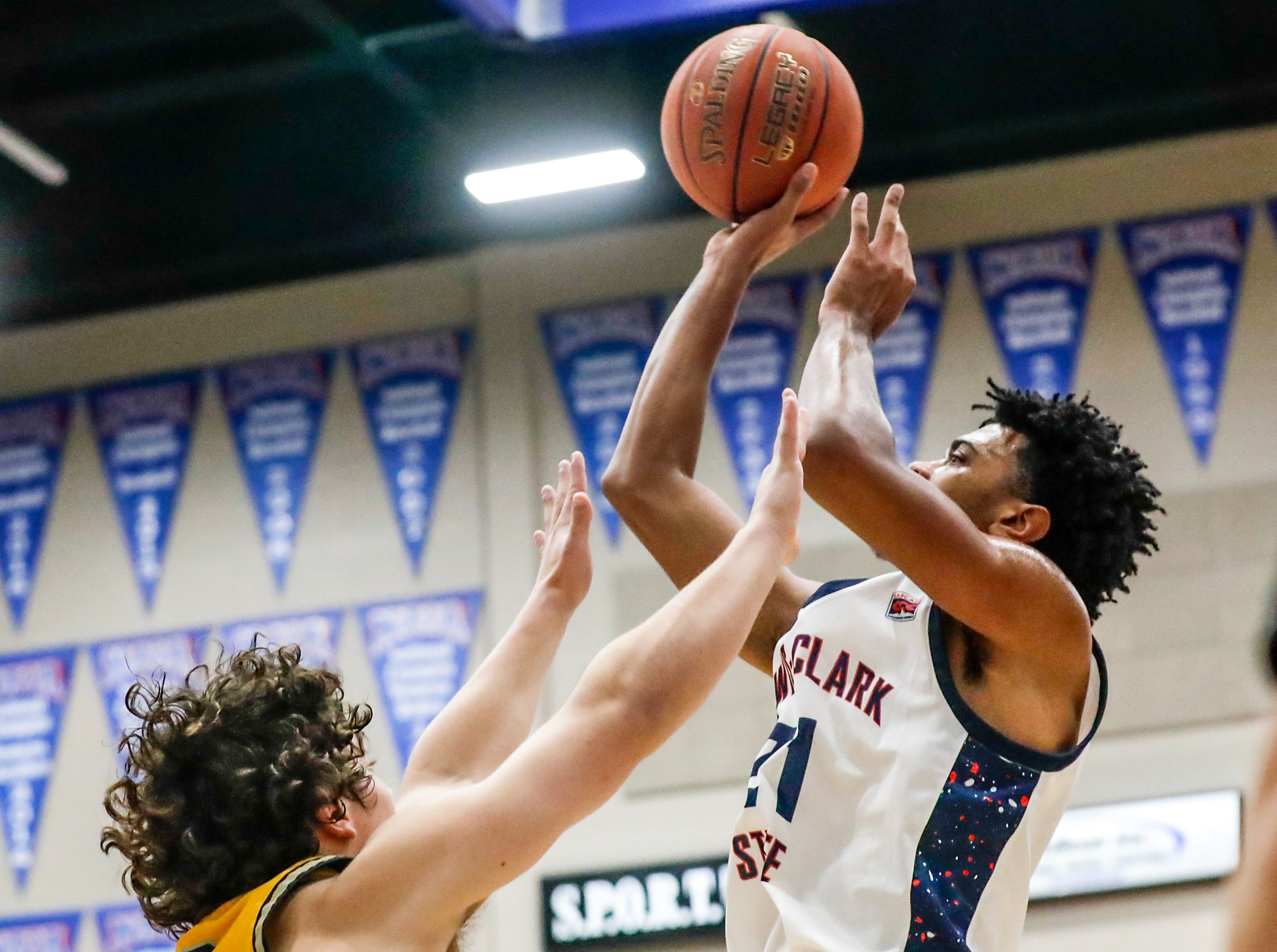 Lewis-Clark State forward Jaedon Bradley shoots the ball over Corban guard Reece Van Lierop during a game Dec. 15 at the P1FCU Activity Center in Lewiston.