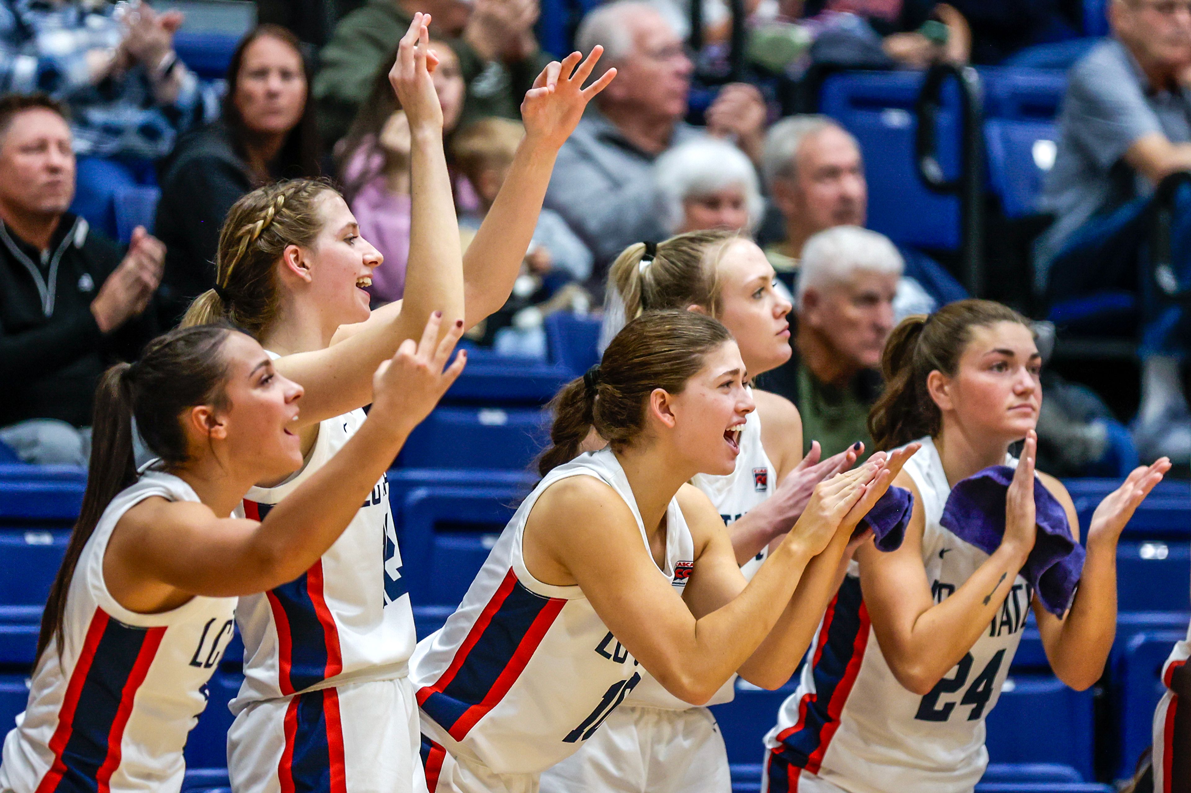 The Lewis-Clark State bench celebrates a three-pointer against Walla Walla during a quarter of a Cascade Conference game Tuesday at Lewis-Clark State College in Lewiston.