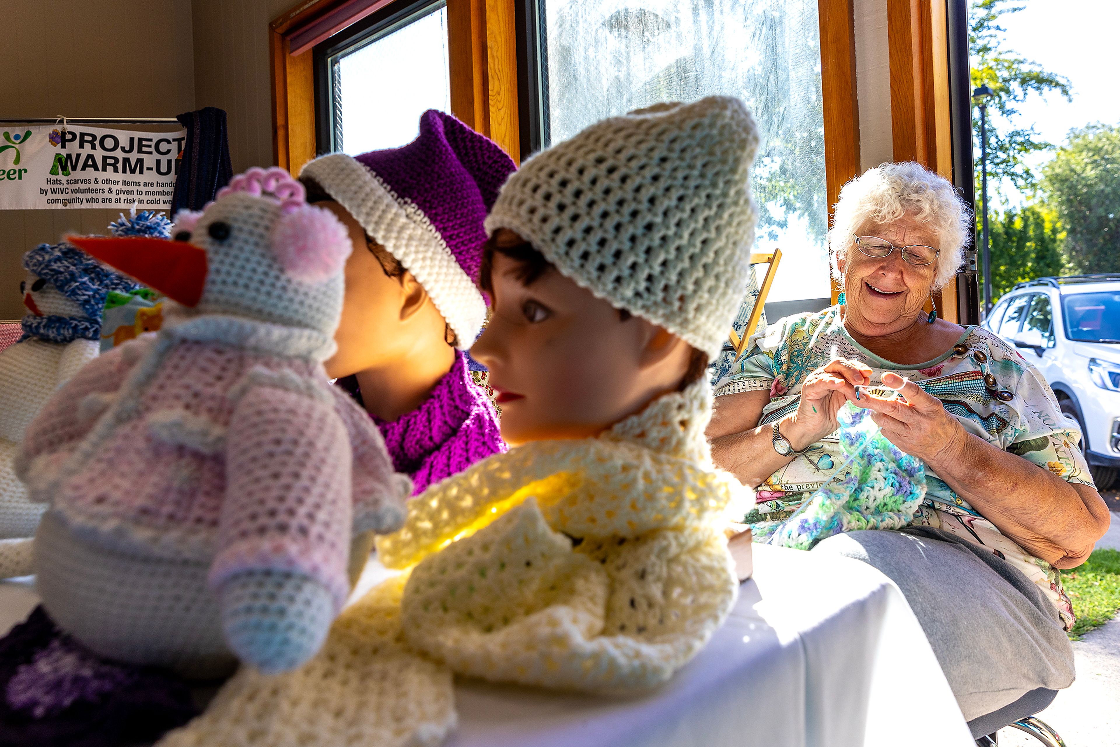 Martha Wemhoff, of Lewiston, knits as she sits at the Project Warm-Up table Thursday during the 2024 Annual Health and Wellness Fair at the Lewiston Community Center.