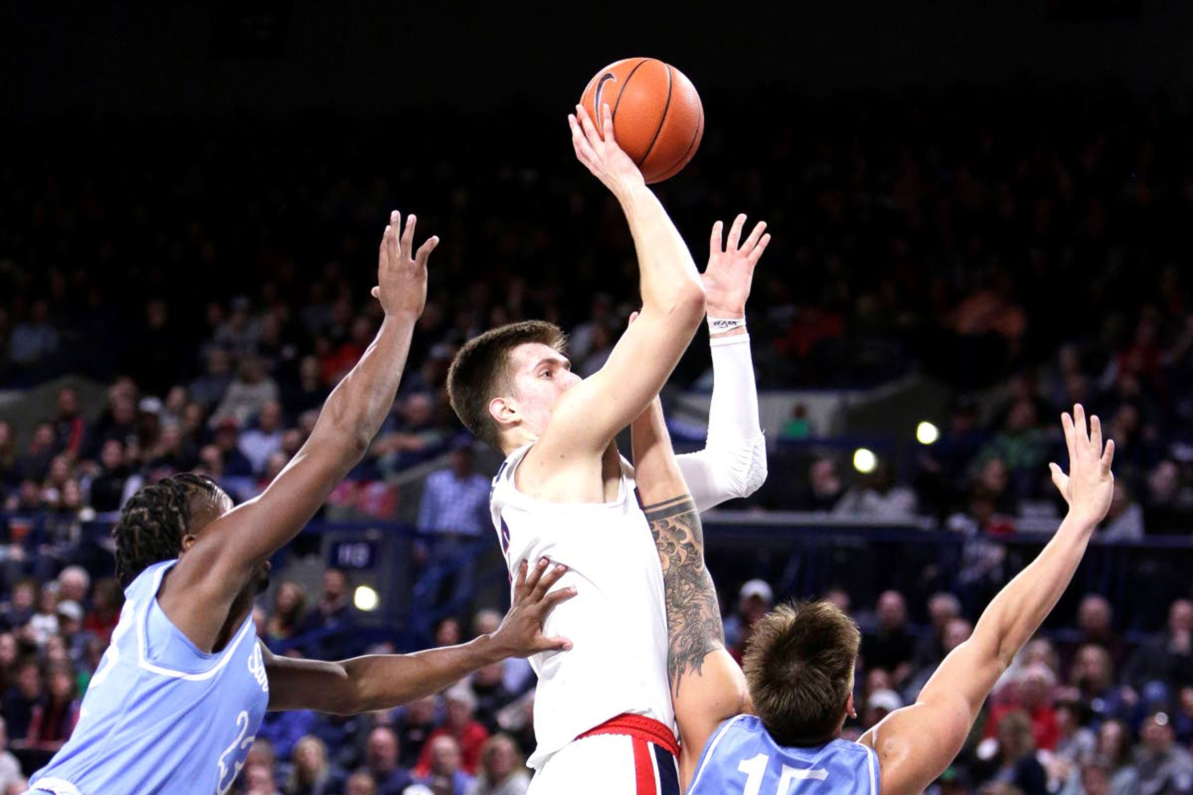 Associated PressGonzaga forward Filip Petrusev shoots between James Jean-Marie (left) and Alex Floresca.