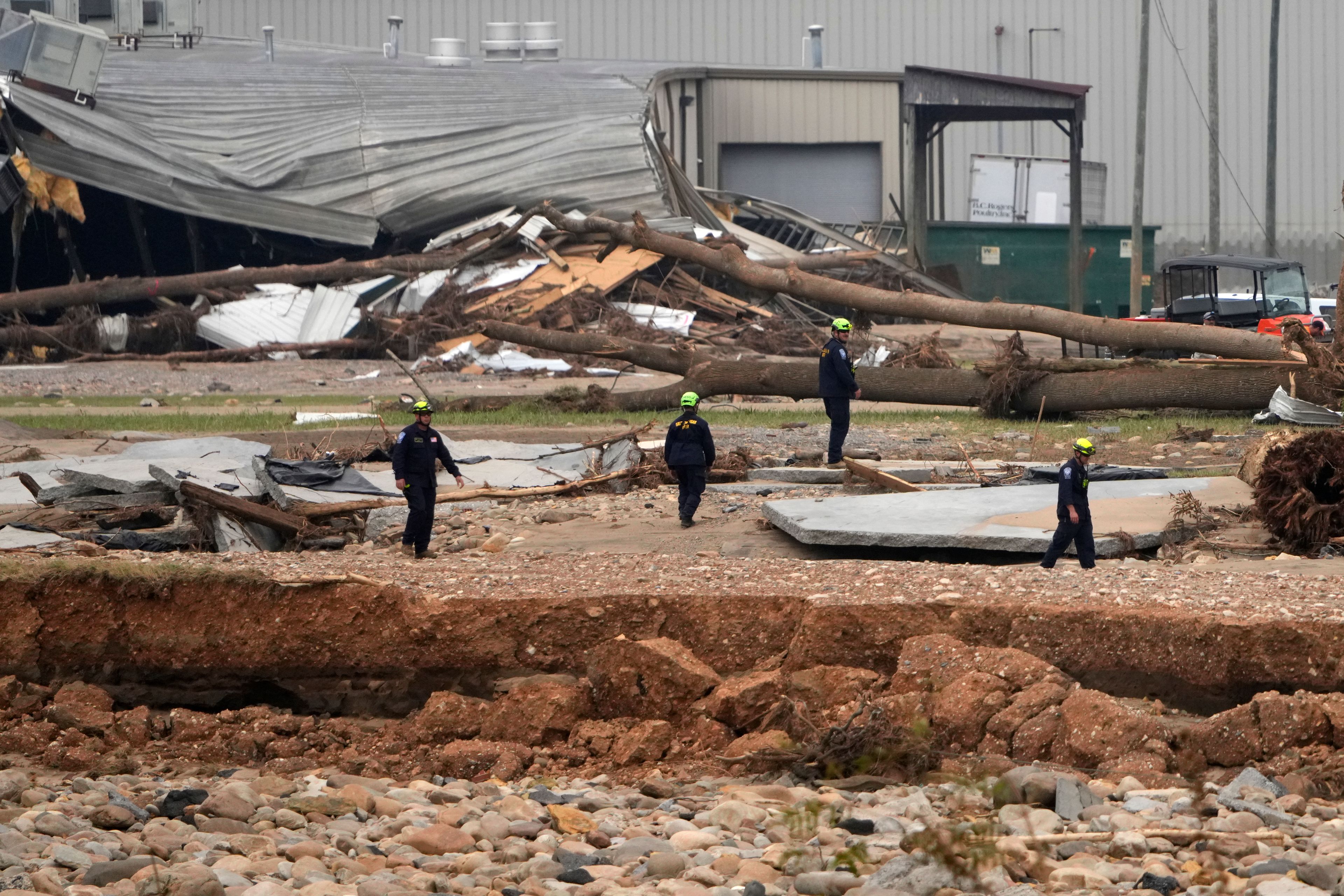 Personnel from Urban Search and Rescue Utah Task Force 1 work in the aftermath of Hurricane Helene Friday, Oct. 4, 2024, in Erwin, Tenn. (AP Photo/Jeff Roberson)