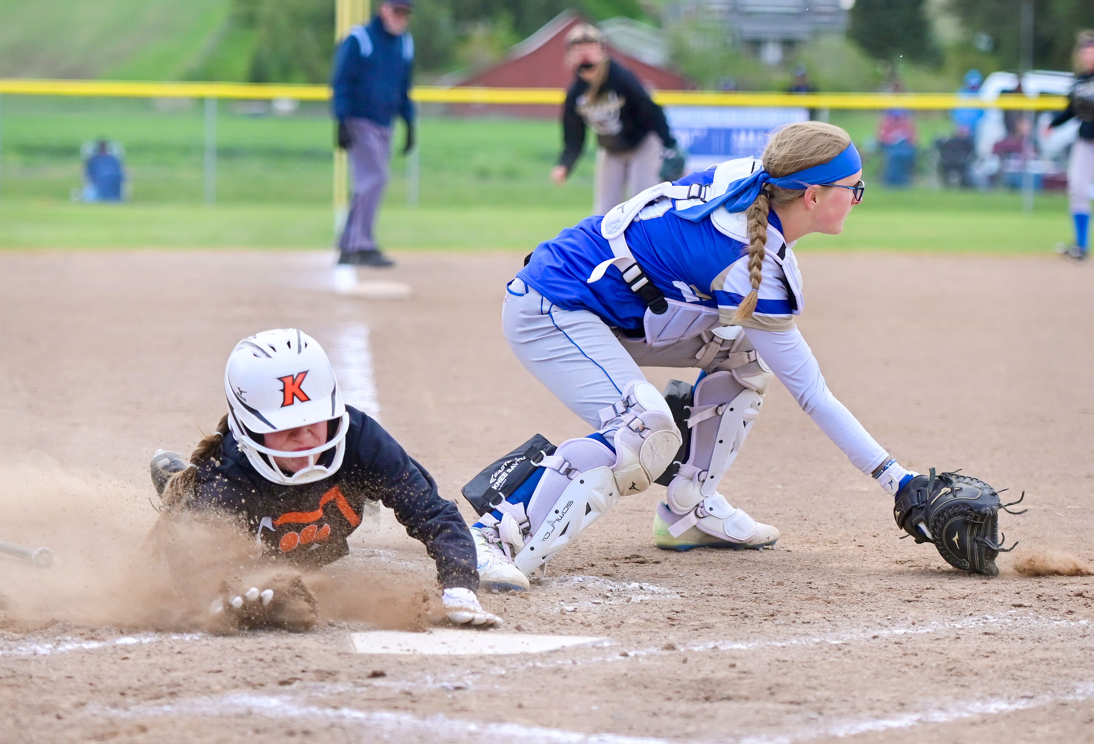 Kendrick’s Hali Anderson dives across home plate as Genesee’s Rylie Baysinger prepares to catch the ball during an Idaho Class 1A state championship game Friday in Genesee.