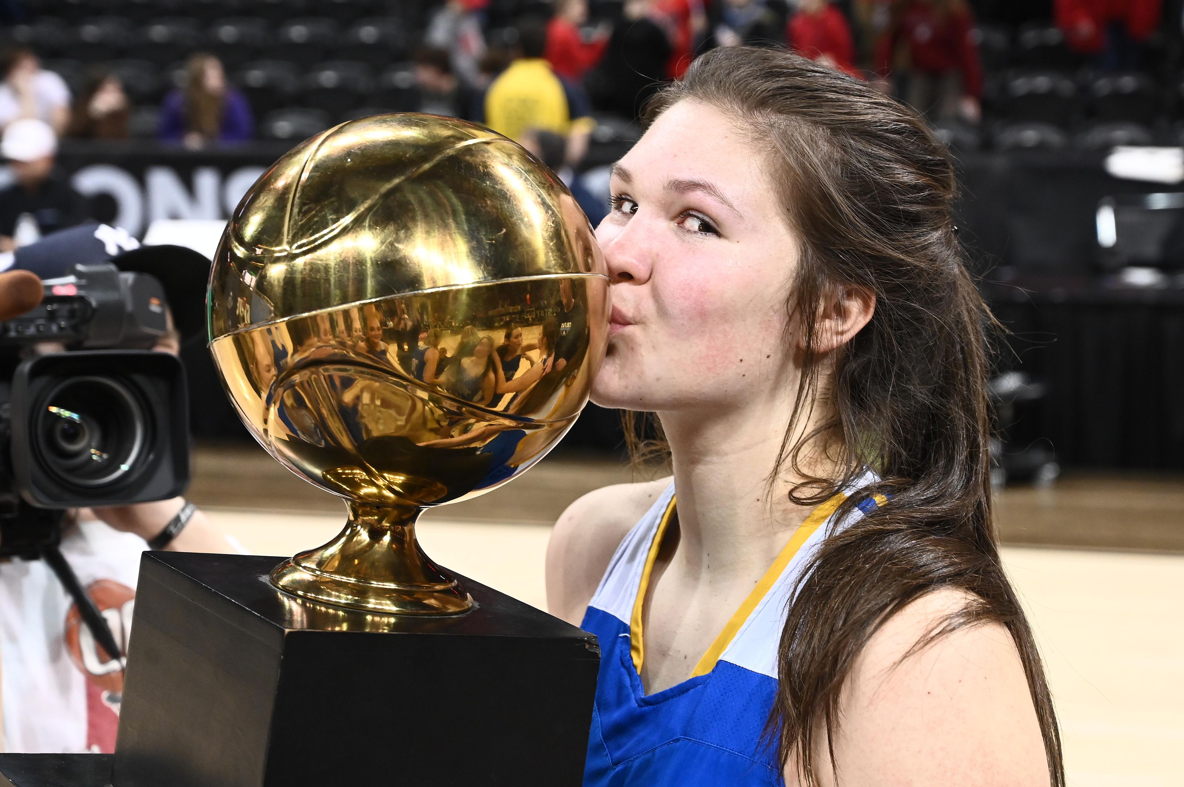 Colfax’s Brynn McGaughy kisses the state championship trophy after the Washington Class 2B girls basketball state title game March 4, 2023, against Okanogan at Spokane Arena.