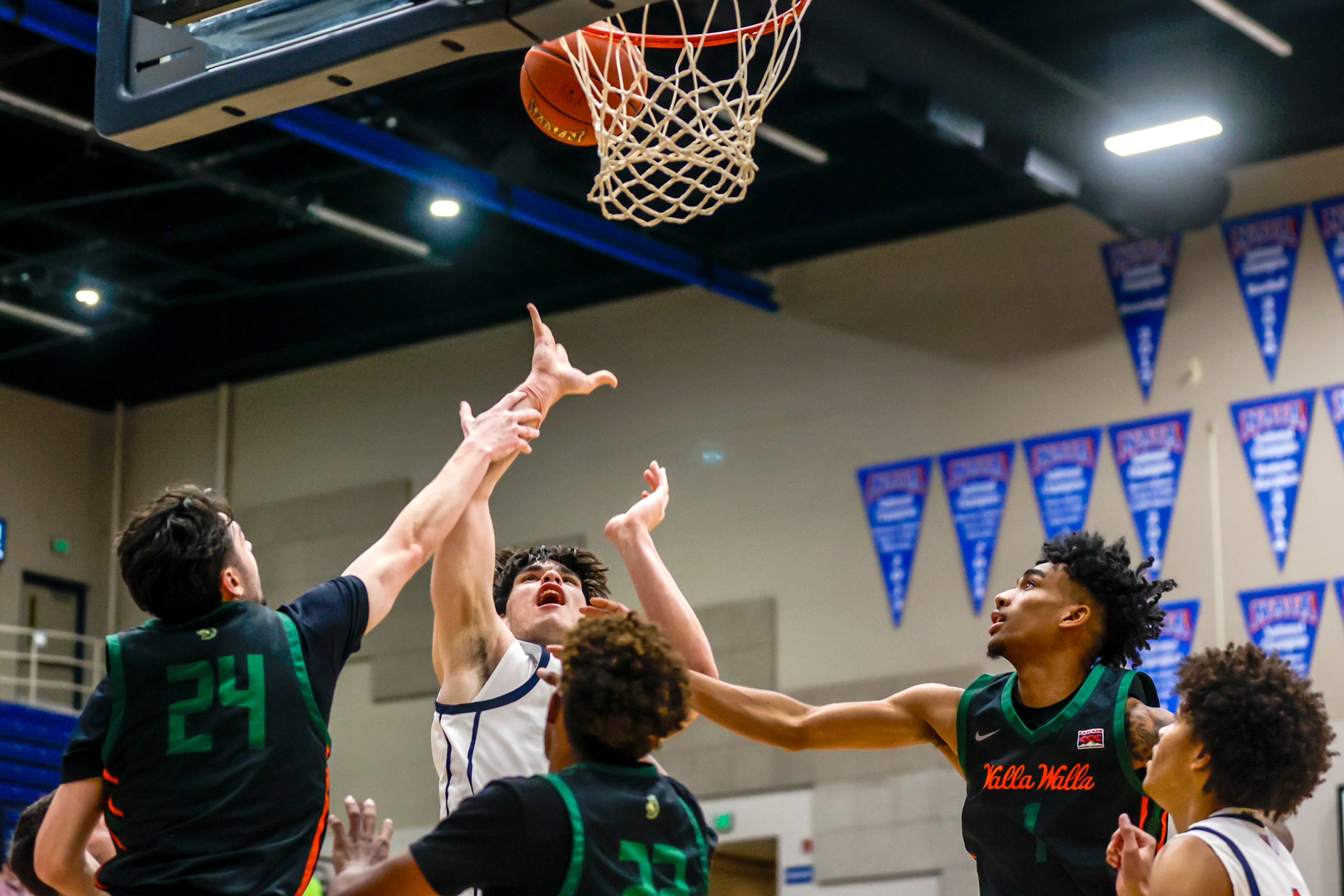 Lewis-Clark State forward Josh Salguero shoots the ball under pressure from Walla Walla during a quarter of a Cascade Conference game Tuesday at Lewis-Clark State College in Lewiston.