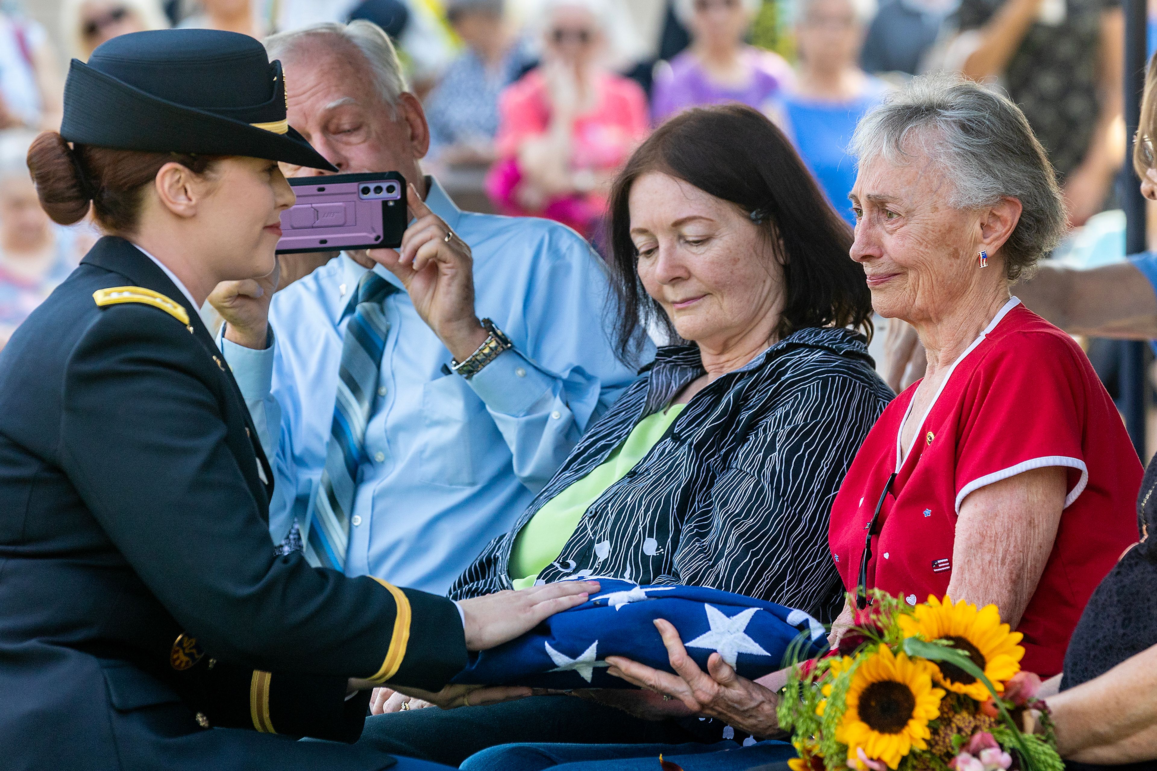 Shirley Finn, Allan Knepper’s half-sister, receives the flag that draped his casket at his funeral Thursday at the Normal Hill Cemetery in Lewiston.