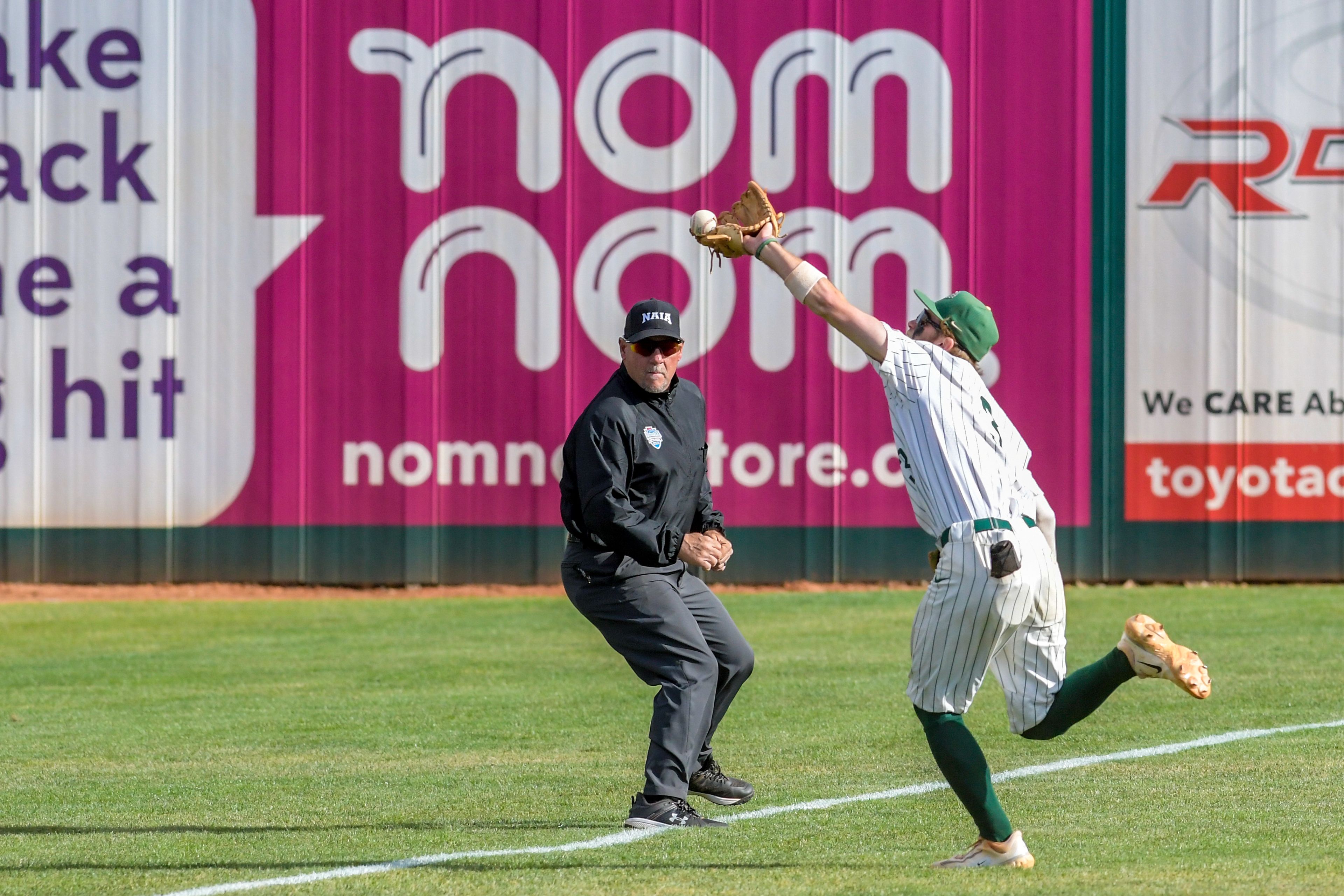 Georgia Gwinnett left fielder Jackson Cobb has the ball bounce off is his glove against Hope International in Game 16 of the NAIA World Series at Harris Field Wednesday in Lewiston. The play was initially called a foul before changed to a missed catch after review.