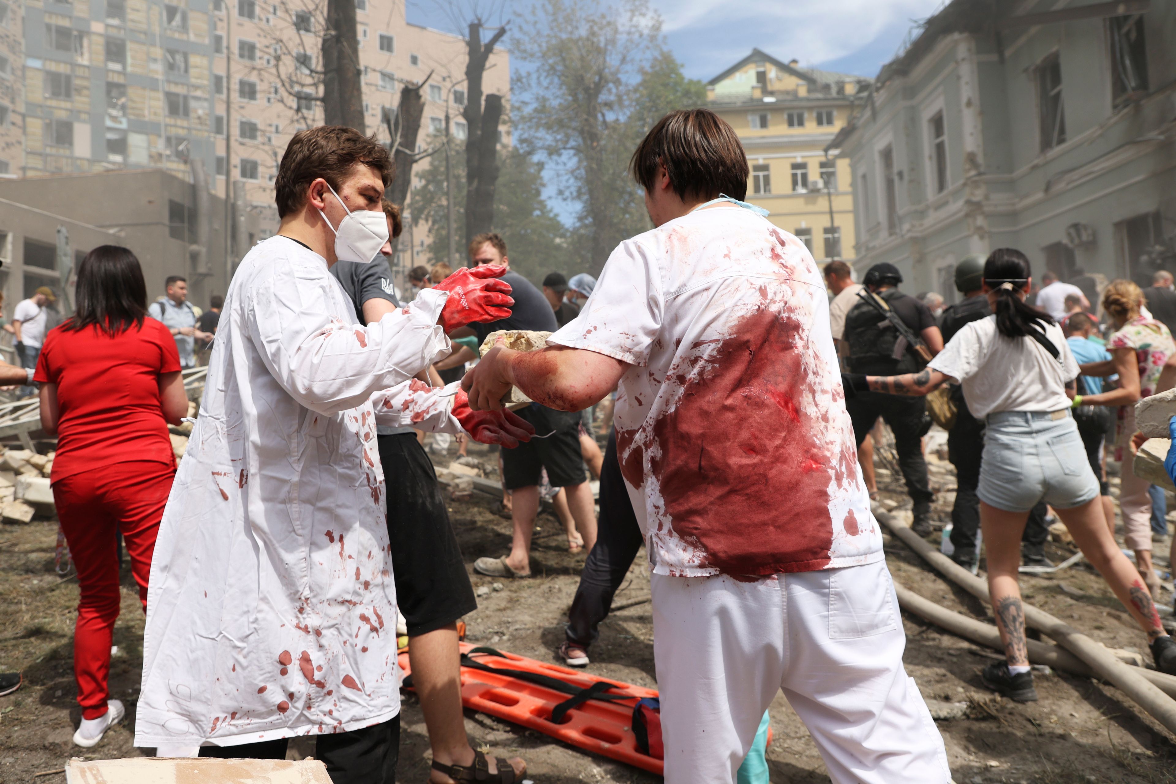 Rescuers, medical staff and volunteers clean up the rubble and search victims after Russian missile hit the country's main children hospital Okhmadit in Kyiv, Ukraine, Monday, July 8, 2024. The daytime barrage targeted five Ukrainian cities with more than 40 missiles of different types hitting apartment buildings and public infrastructure, President Volodymyr Zelenskyy said on social media. (AP Photo/Anton Shtuka)