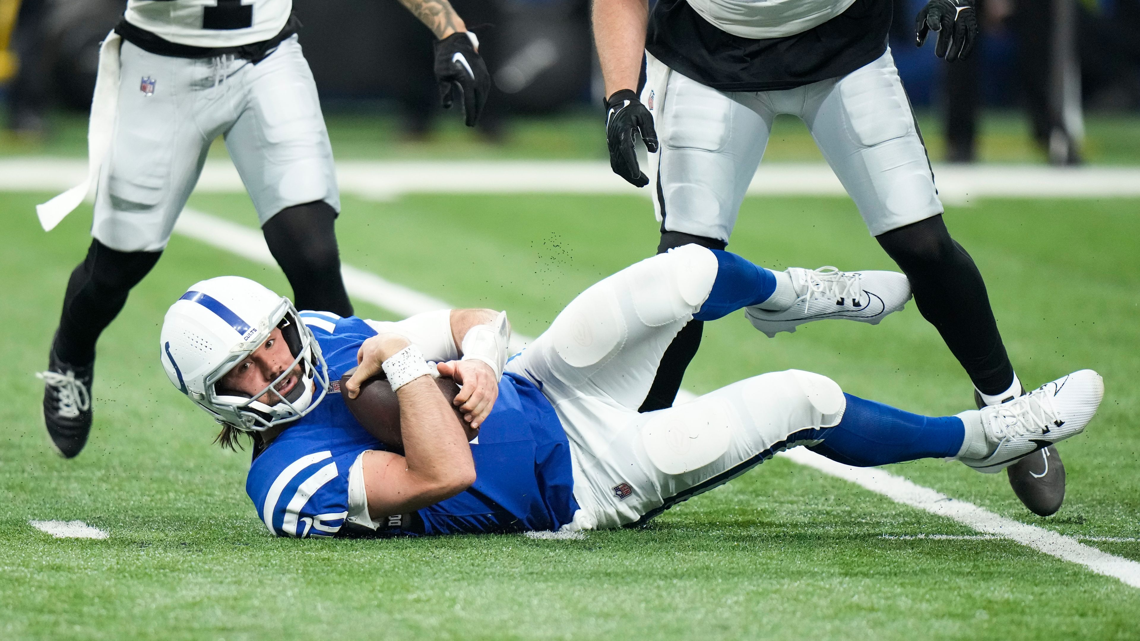 Colts quarterback Gardner Minshew slides but comes up short as he tries for a first down during the first half of a game against the Raiders on Sunday in Indianapolis.