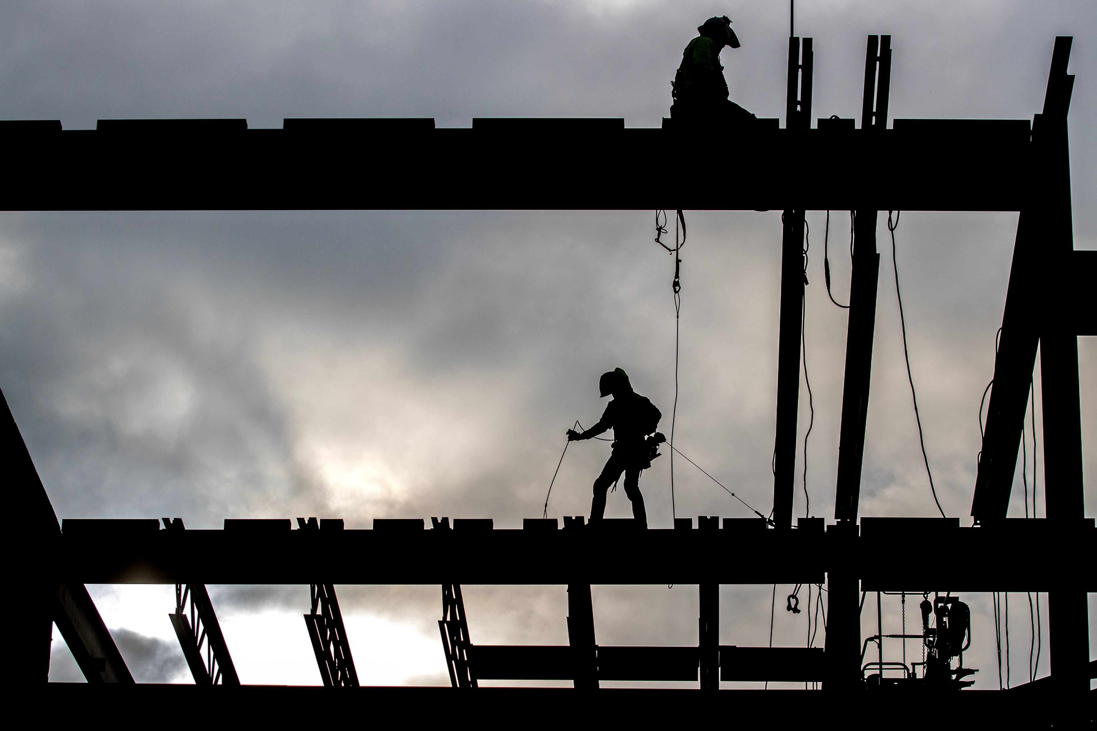 Workers walk across the beams while working on the new courthouse Thursday, Jan. 4, in Lewiston.