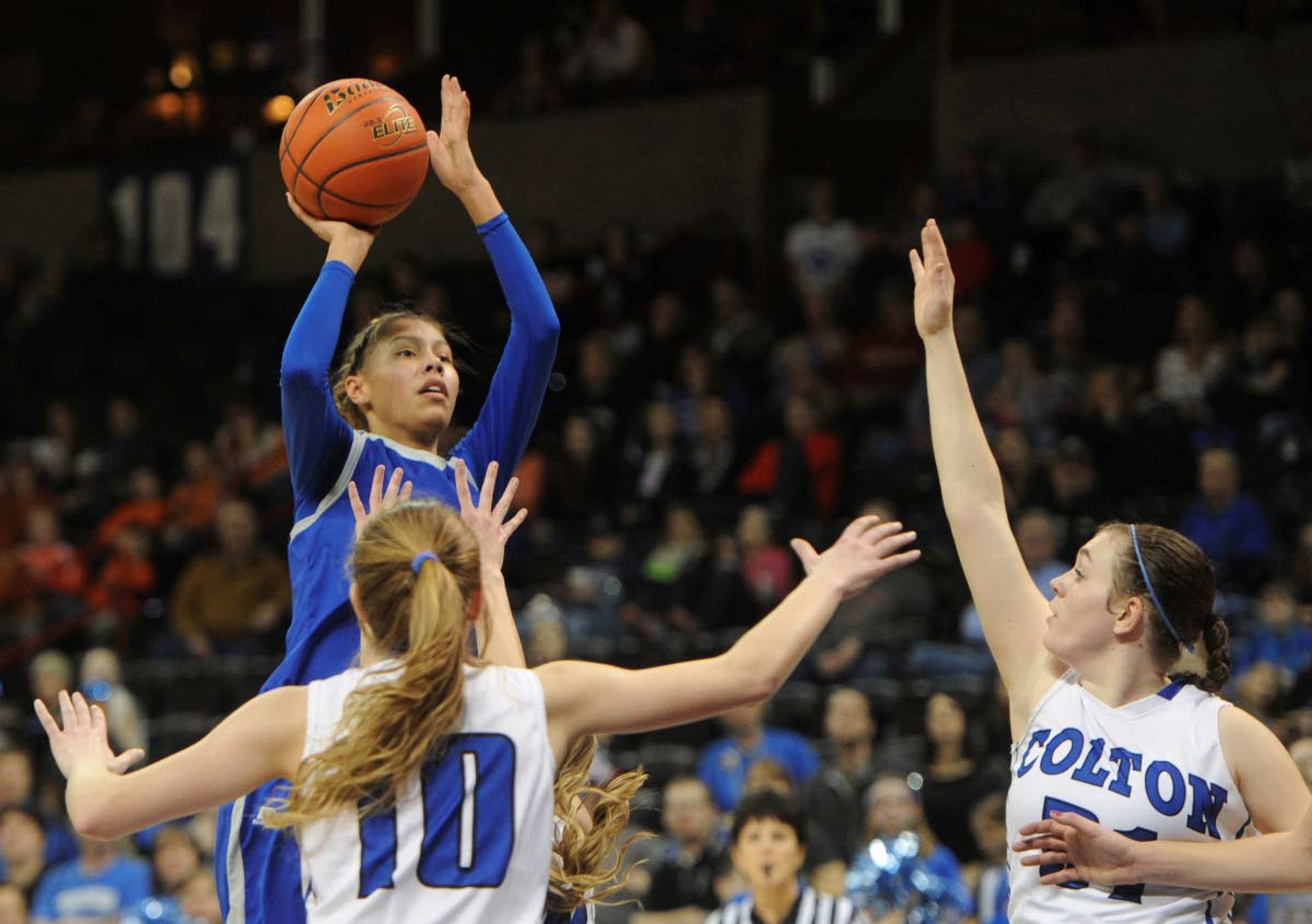 In this March 8, 2014, photo, Tekoa-Oakesdale’s Olivia Pakootas (23) shoots over Colton during the first half of a WIAA Girls 1B championship basketball game at Spokane Veterans Memorial Arena in Spokane.