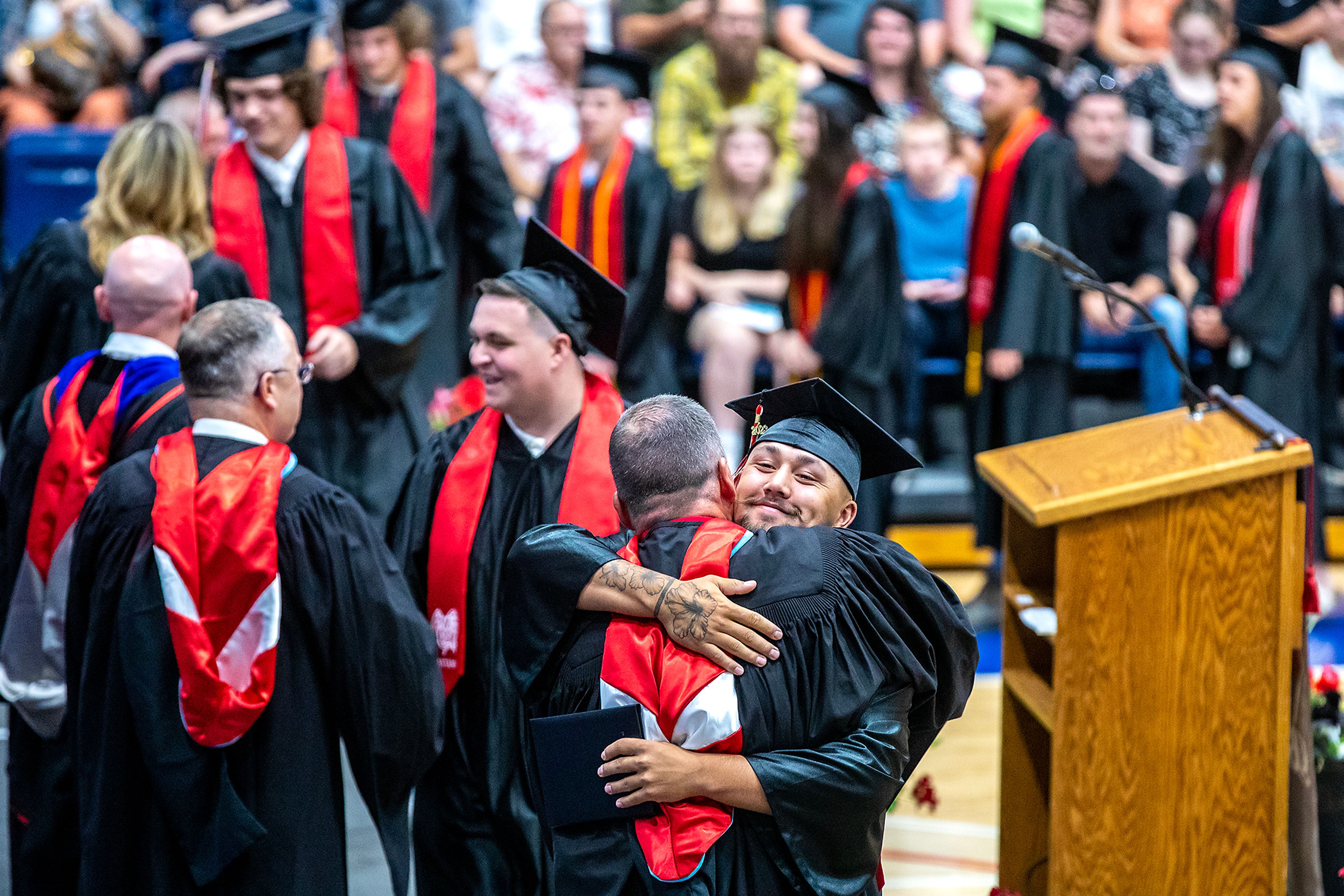 A graduate is congratulated after receiving his diploma at the Clarkston High School 2023 graduation ceremony at the Lewis-Clark State College Activity Center.