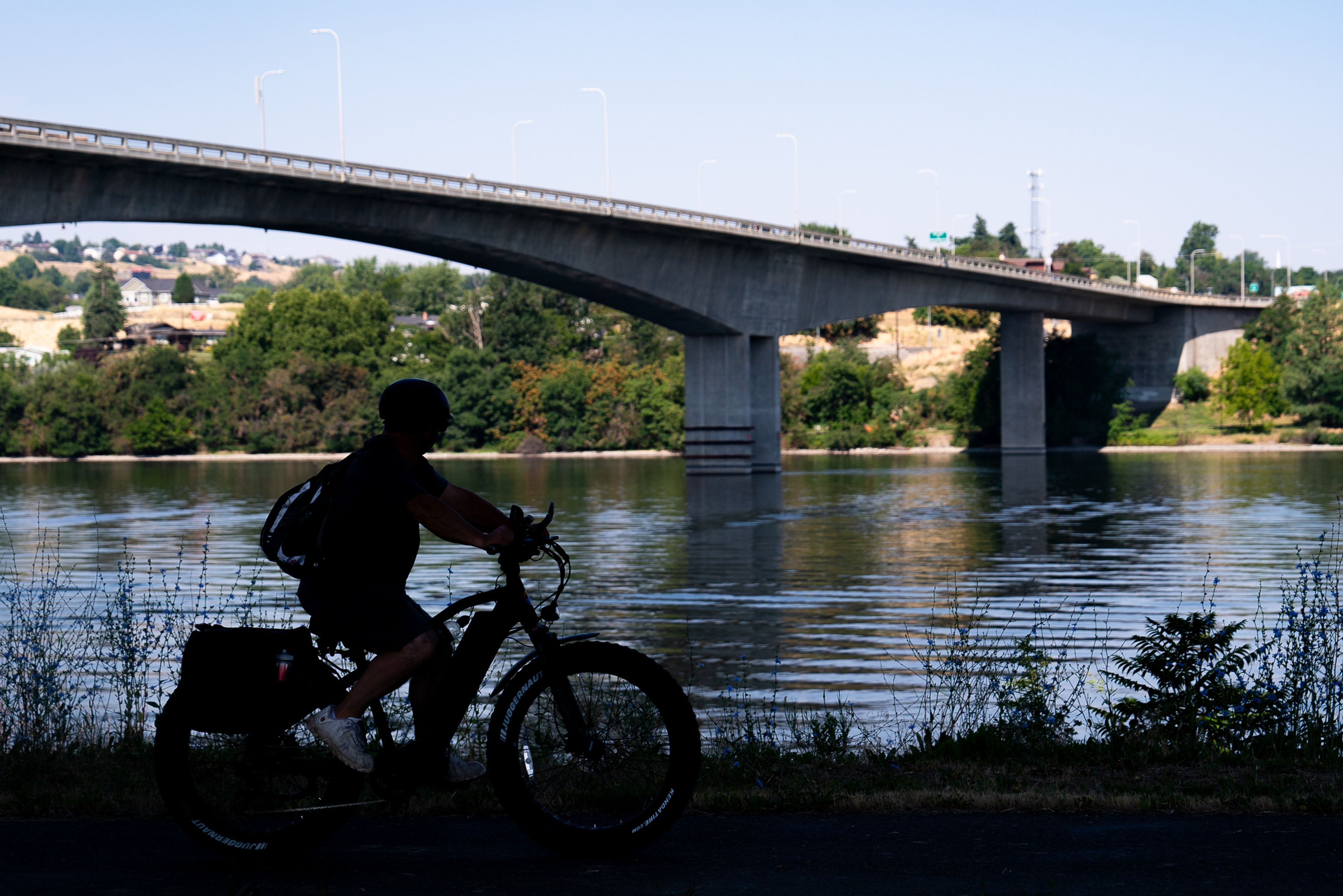 A cyclist looks out at the Southway Bridge during their ride on Friday morning in Lewiston.