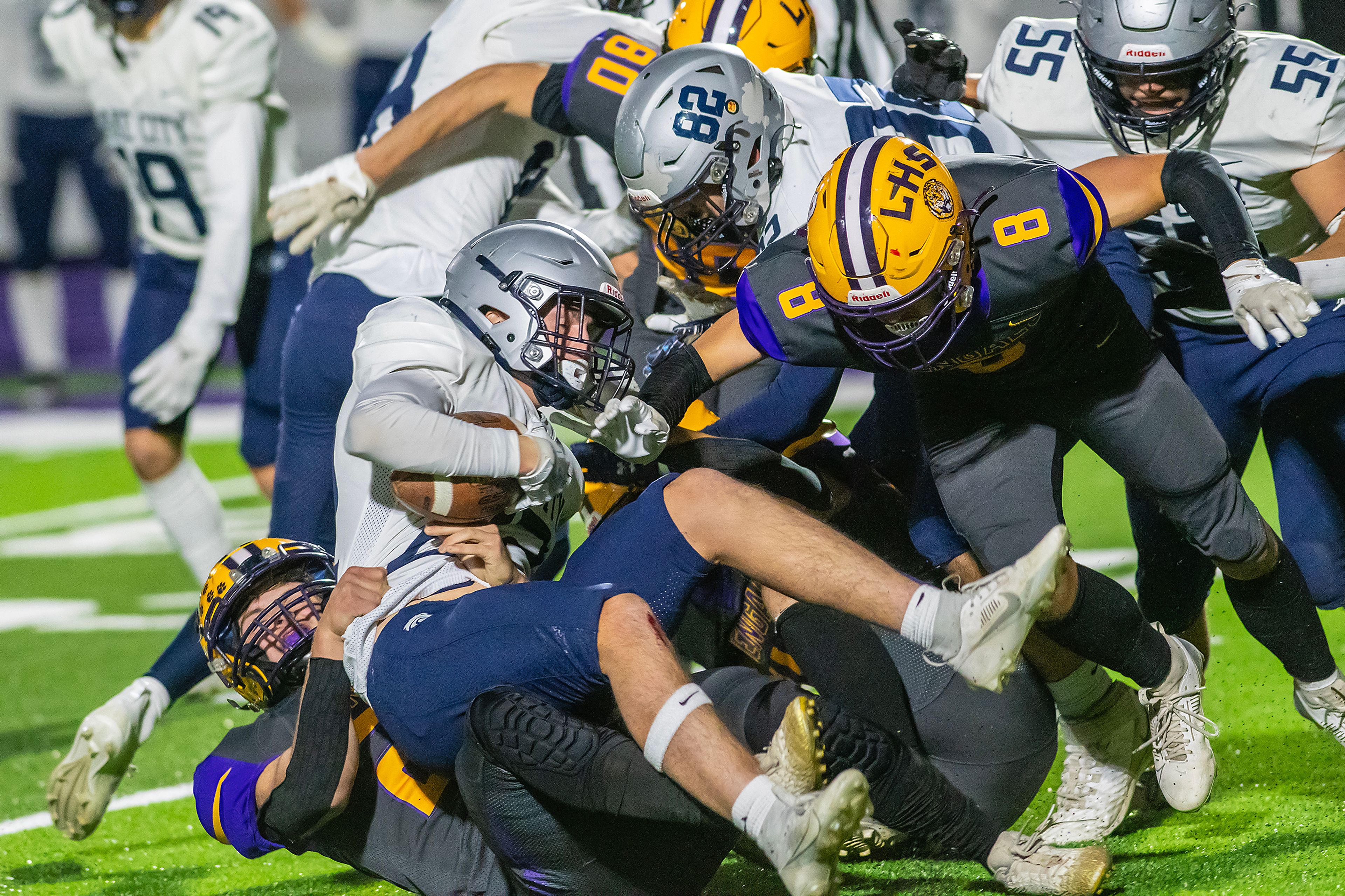 Lake City running back Gabe Wullenwaber is brought down by Lewiston linebacker Brock Thompson in a nonconference game Friday at Lewiston High School.,