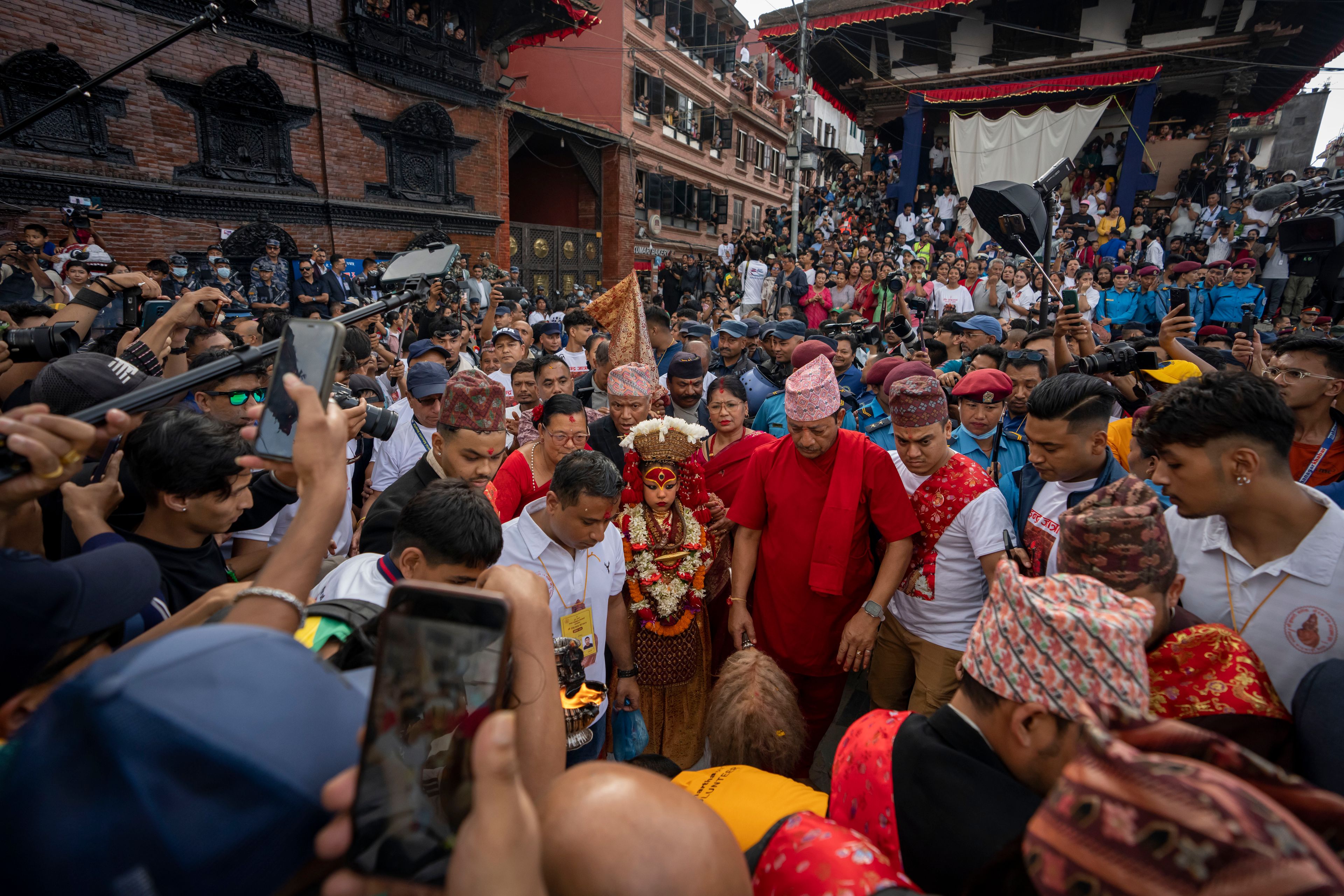 Living goddess Kumari is directed towards a chariot during Indra Jatra, a festival that marks the end of the rainy season in Kathmandu, Nepal, Tuesday, Sept. 17, 2024. (AP Photo/Niranjan Shrestha)