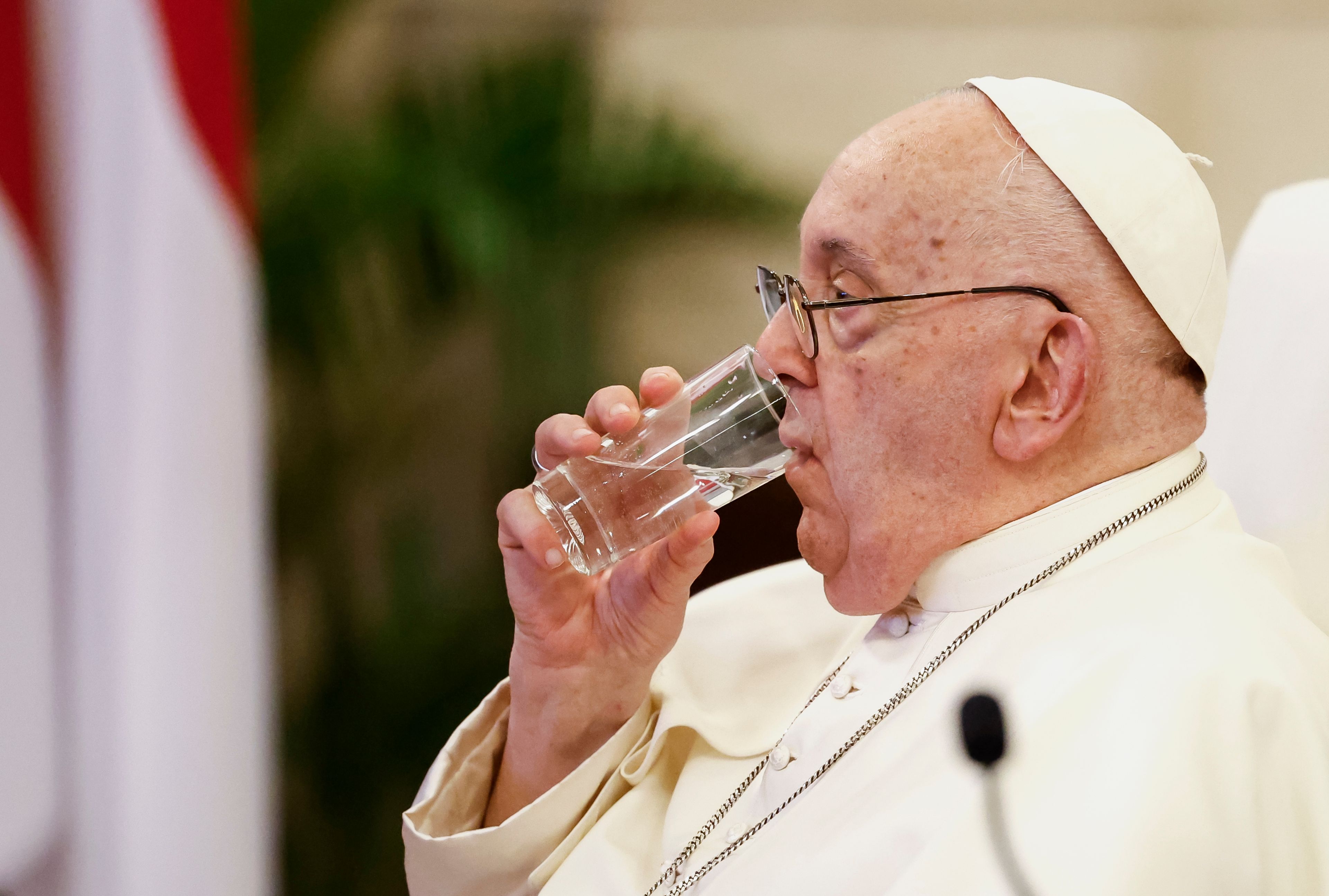 Pope Francis drinks water as he attends a meeting with Indonesian authorities, civil society and the diplomatic corps, during his apostolic visit to Asia, at the Presidential Palace in Jakarta Wednesday, Sept. 4, 2024.