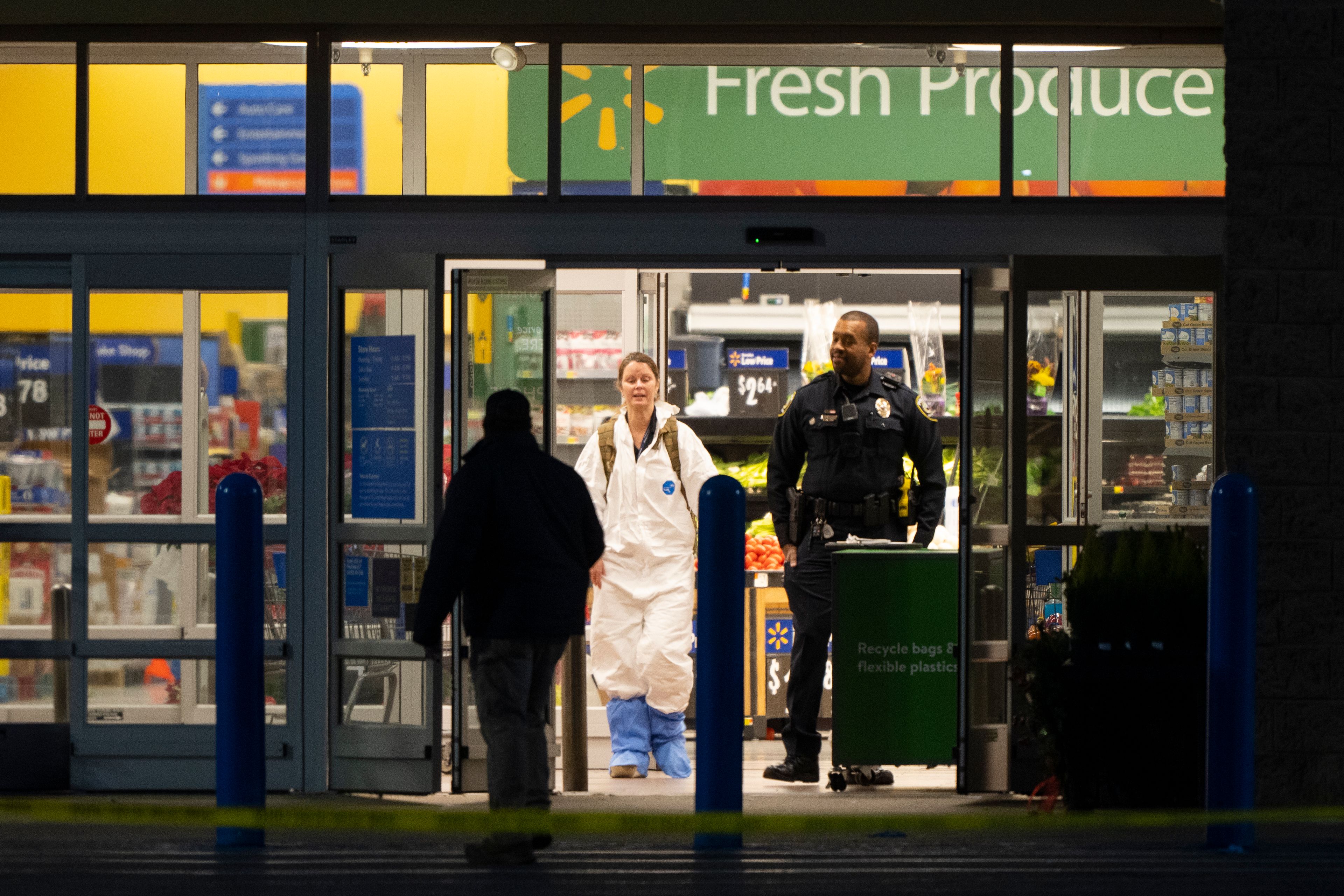 A law enforcement investigator wears a protective covering as they work the scene of a mass shooting at a Walmart, Wednesday, Nov. 23, 2022, in Chesapeake, Va. (AP Photo/Alex Brandon)