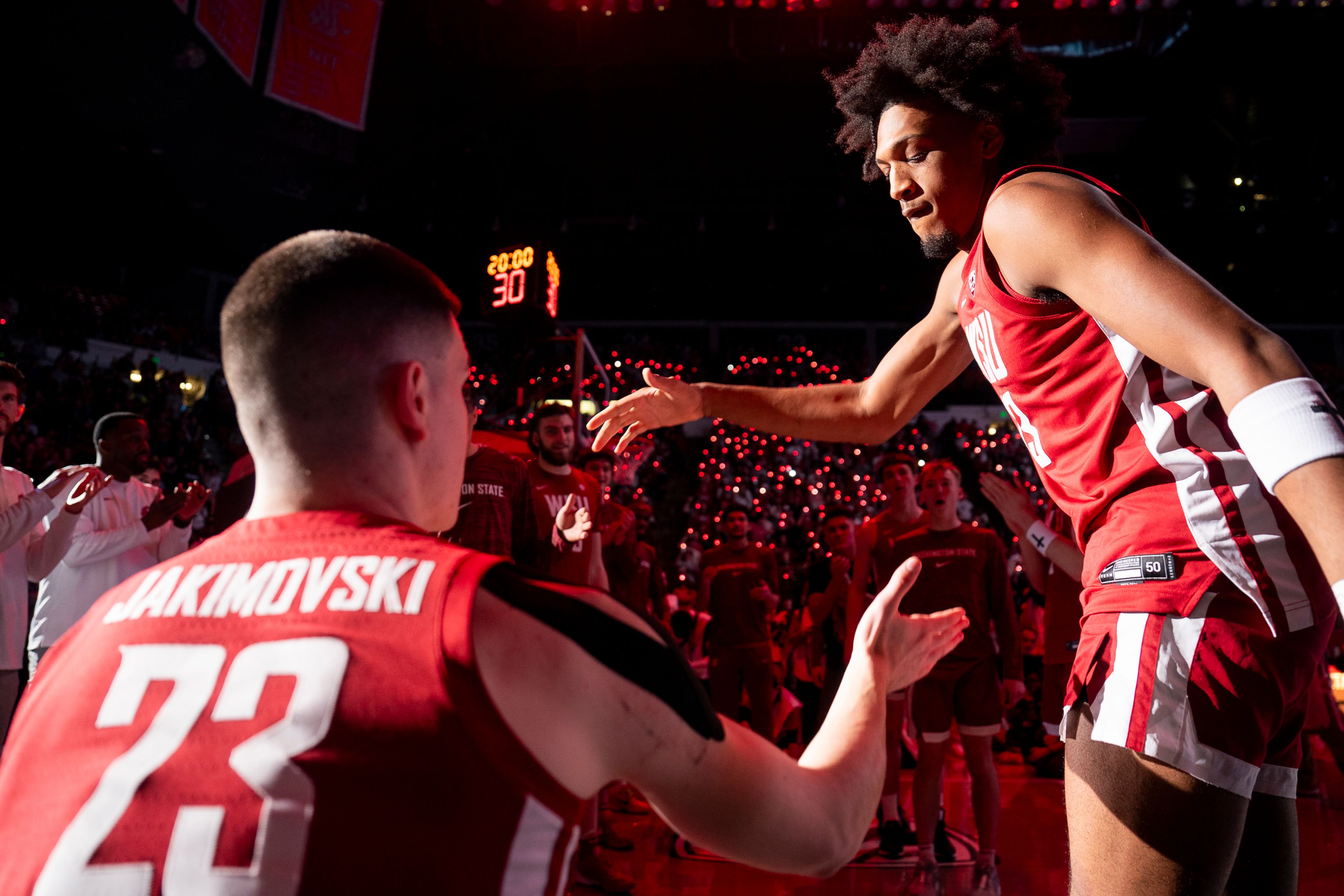 Washington State’s Isaac Jones, right, high-fives Andrej Jakimovski during player introductions before an Apple Cup series game against Washington last season at Beasley Coliseum in Pullman.