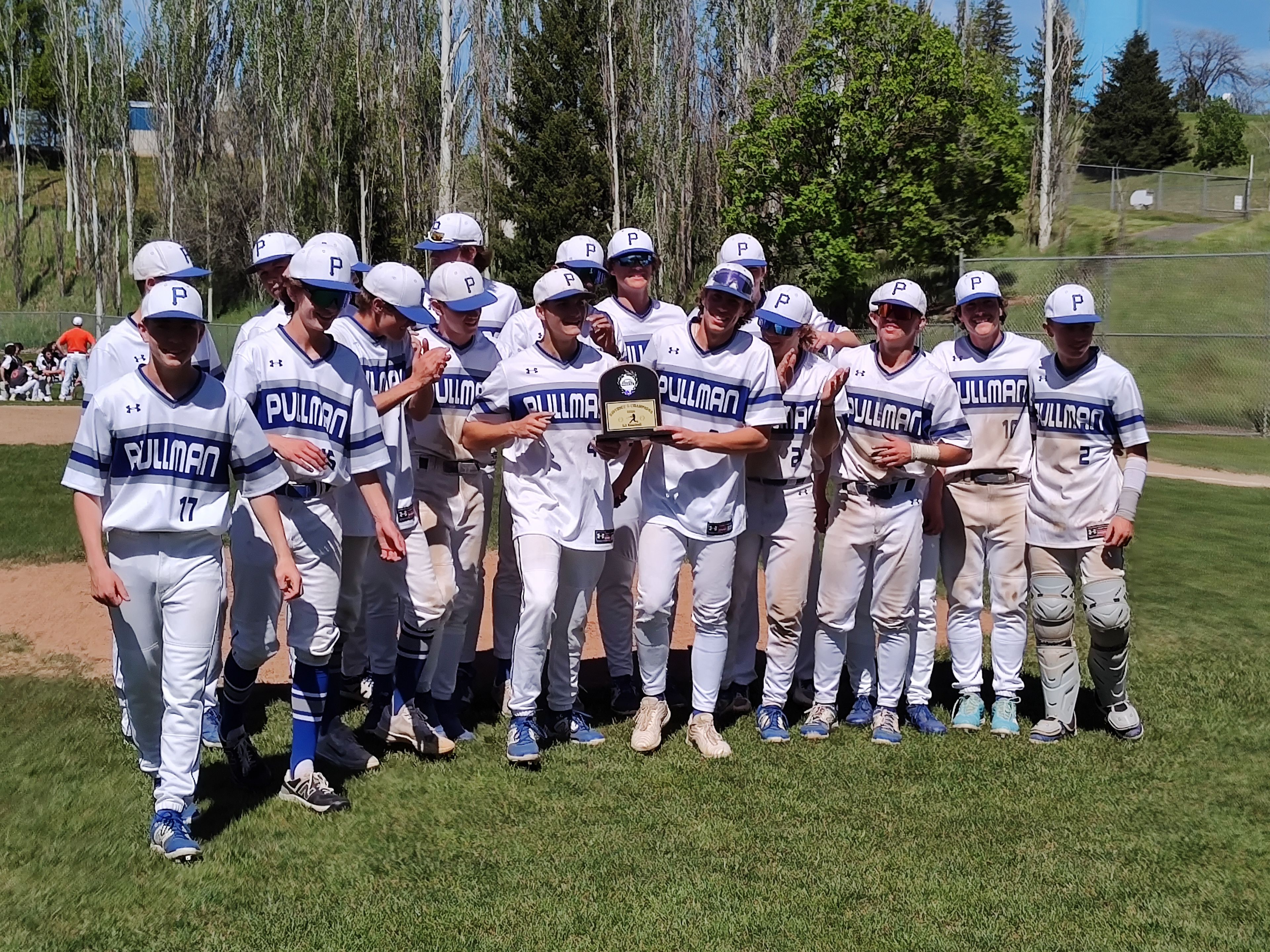 The Pullman baseball team poses with its Washington 2A district championship trophy after defeating West Valley 8-4 on Saturday, May 11, 2024, at Pullman High School.