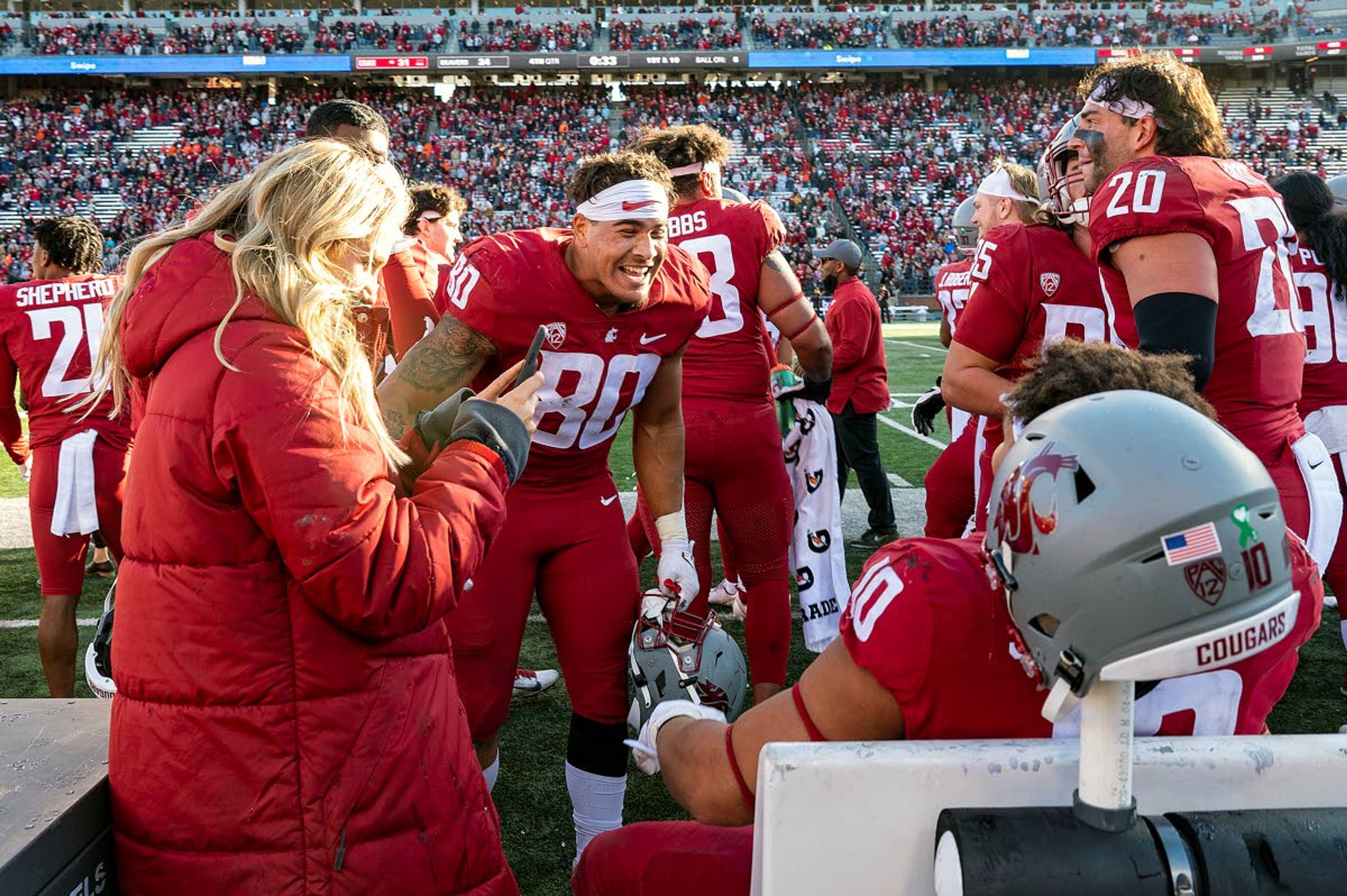 Washington State defensive ends Brennan Jackson, center, celebrates with defensive end Ron Stone Jr., sitting, each were named to the All-Pac-12 team Tuesday.