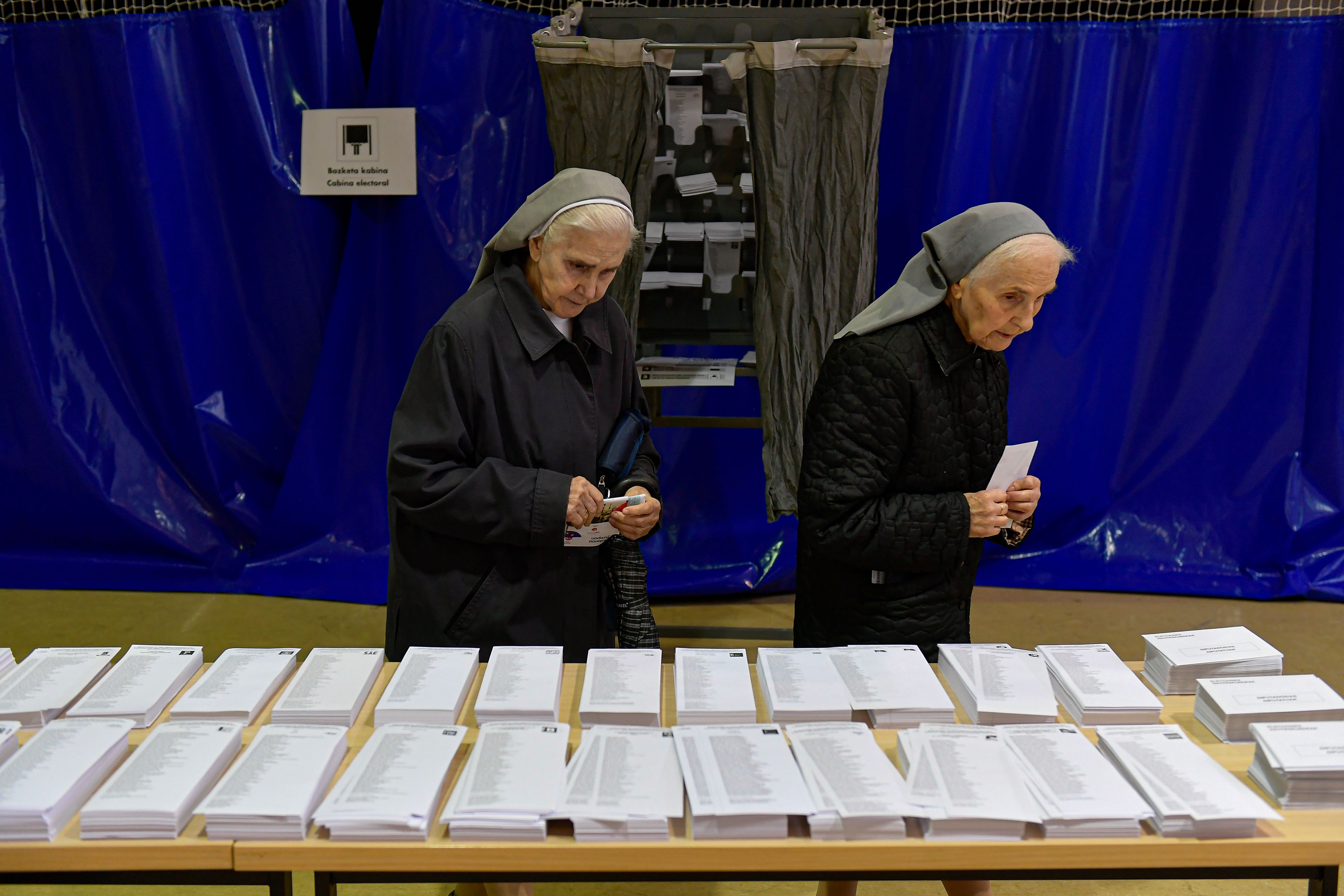 Nuns look at ballot papers at a polling station in Pamplona, northern Spain, on Sunday, June 9, 2024. Pivotal elections for the European Union parliament reach their climax Sunday as the last 27 nations go to the polls and results are announced in a vote that boils down to a continent-wide battle between eurosceptic populists and proponents of closer EU unity.