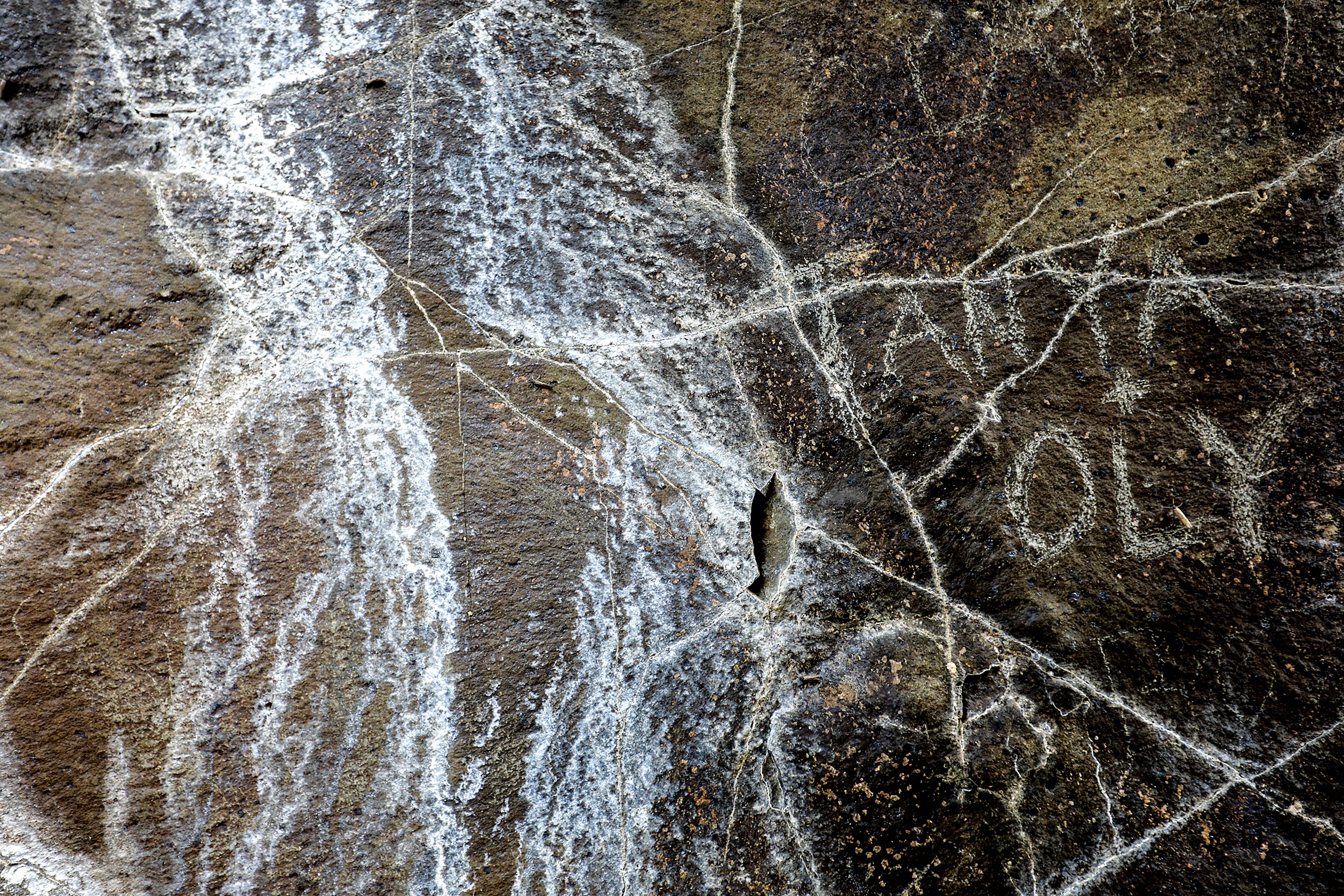 LEFT: “Anya + Oly” is written on the inside of the Hole in the Wall along the Grande Ronde River.right: Holes, intended to house dynamite, are seen inside the Hole in the Wall along the Grande Ronde River.