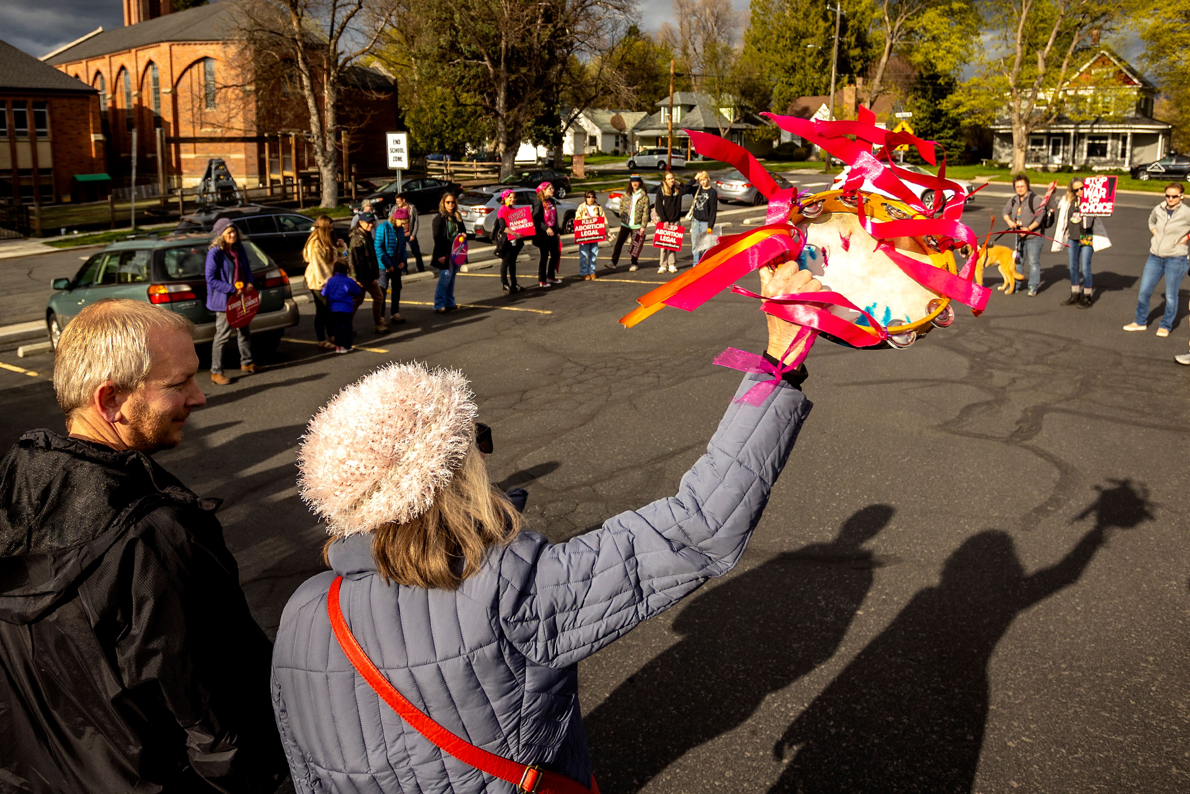 A protester waves a tambourine in the air during a protest in favor of maintaining Roe v. Wade in Moscow on Tuesday evening.