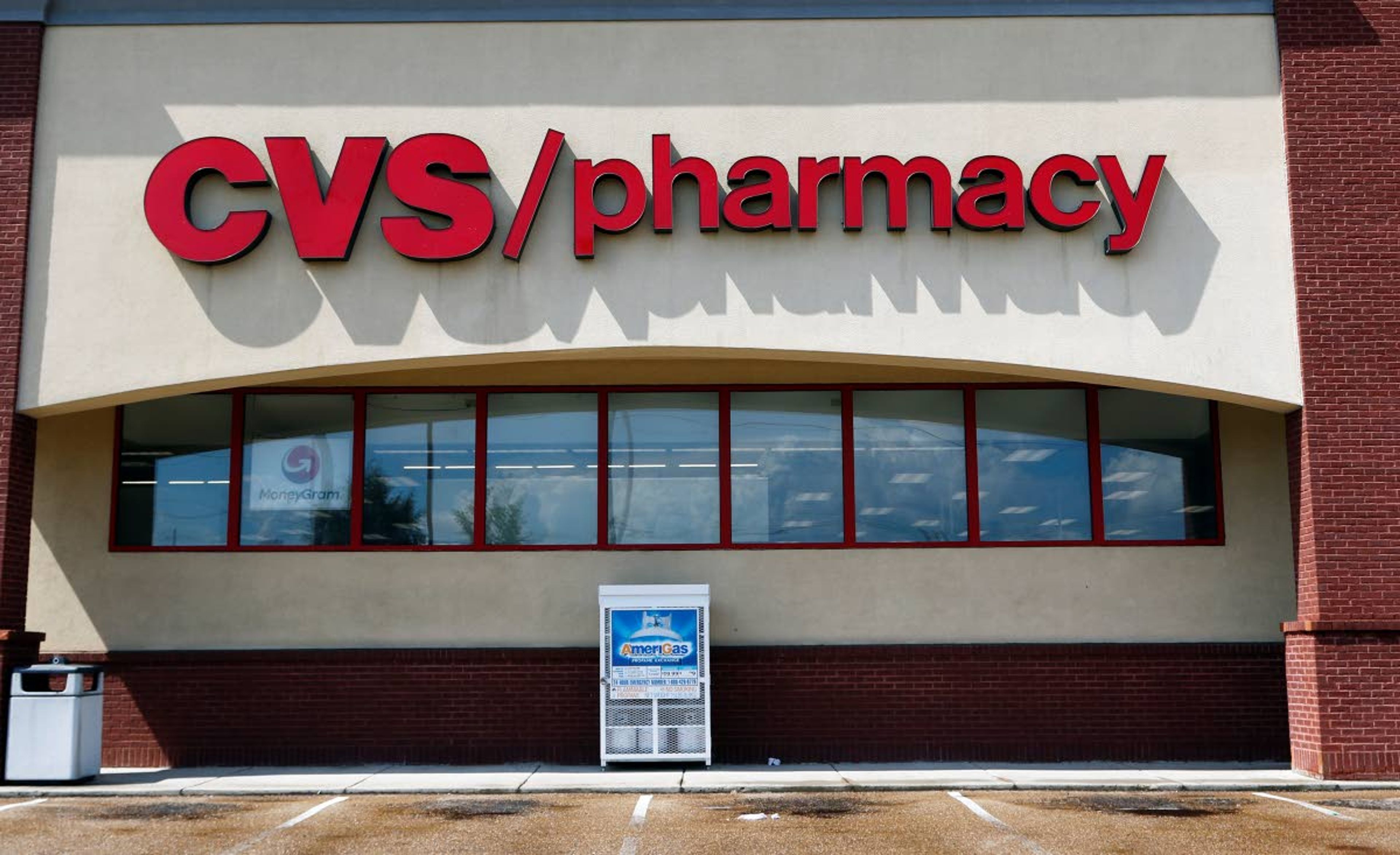 FILE- In this Aug. 7, 2018, file photo a CVS Pharmacy building sign rests on a Jackson, Miss., store. CVS Health reports financial results Wednesday, May 1, 2019. (AP Photo/Rogelio V. Solis, File)