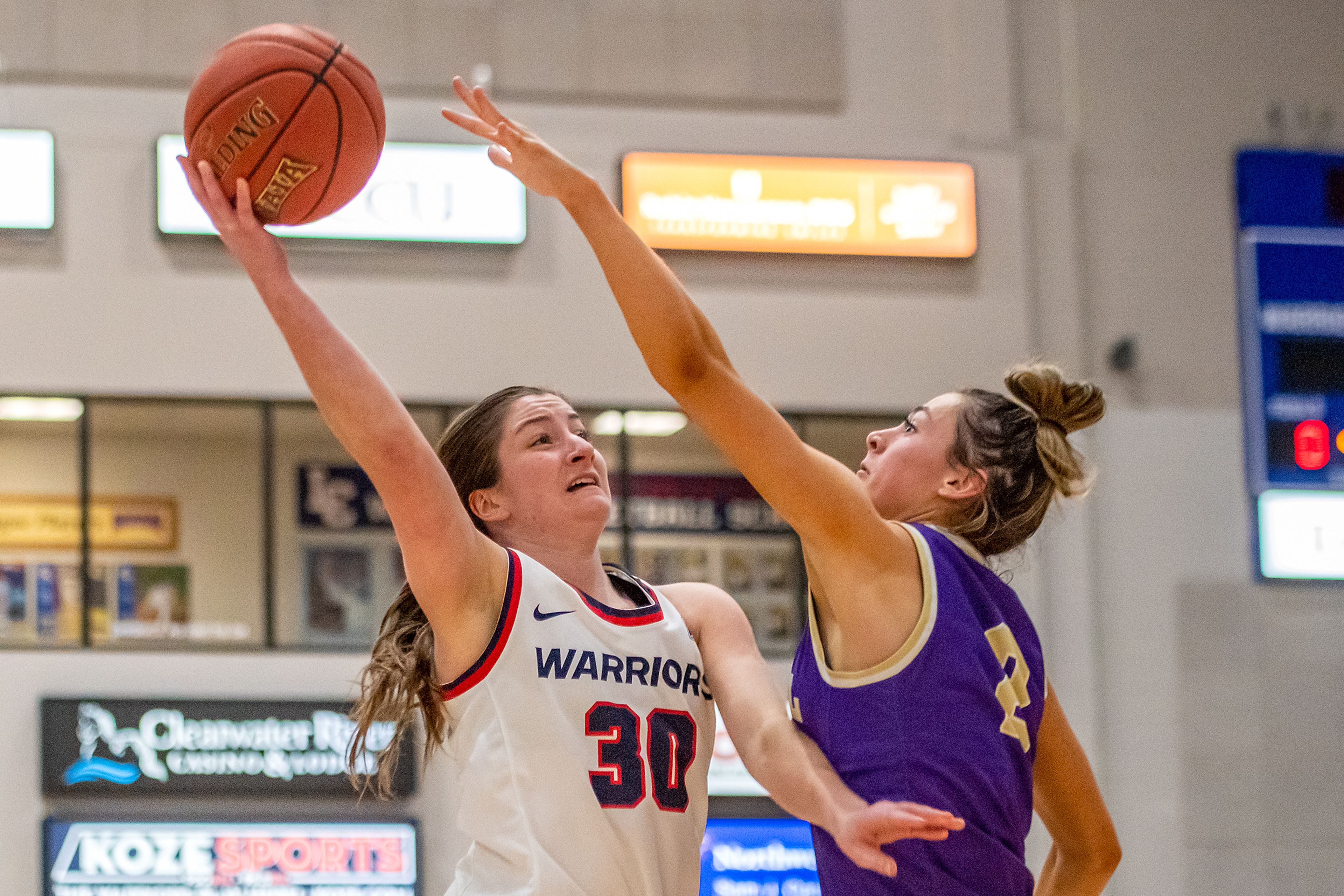 Lewis-Clark State guard Hannah Broyles, left, shoots during Friday’s game against No. 9 Carroll. She led the 13th-ranked Warriors with 16 points in Saturday’s nonconference win against George Fox at the P1FCU Activity Center.