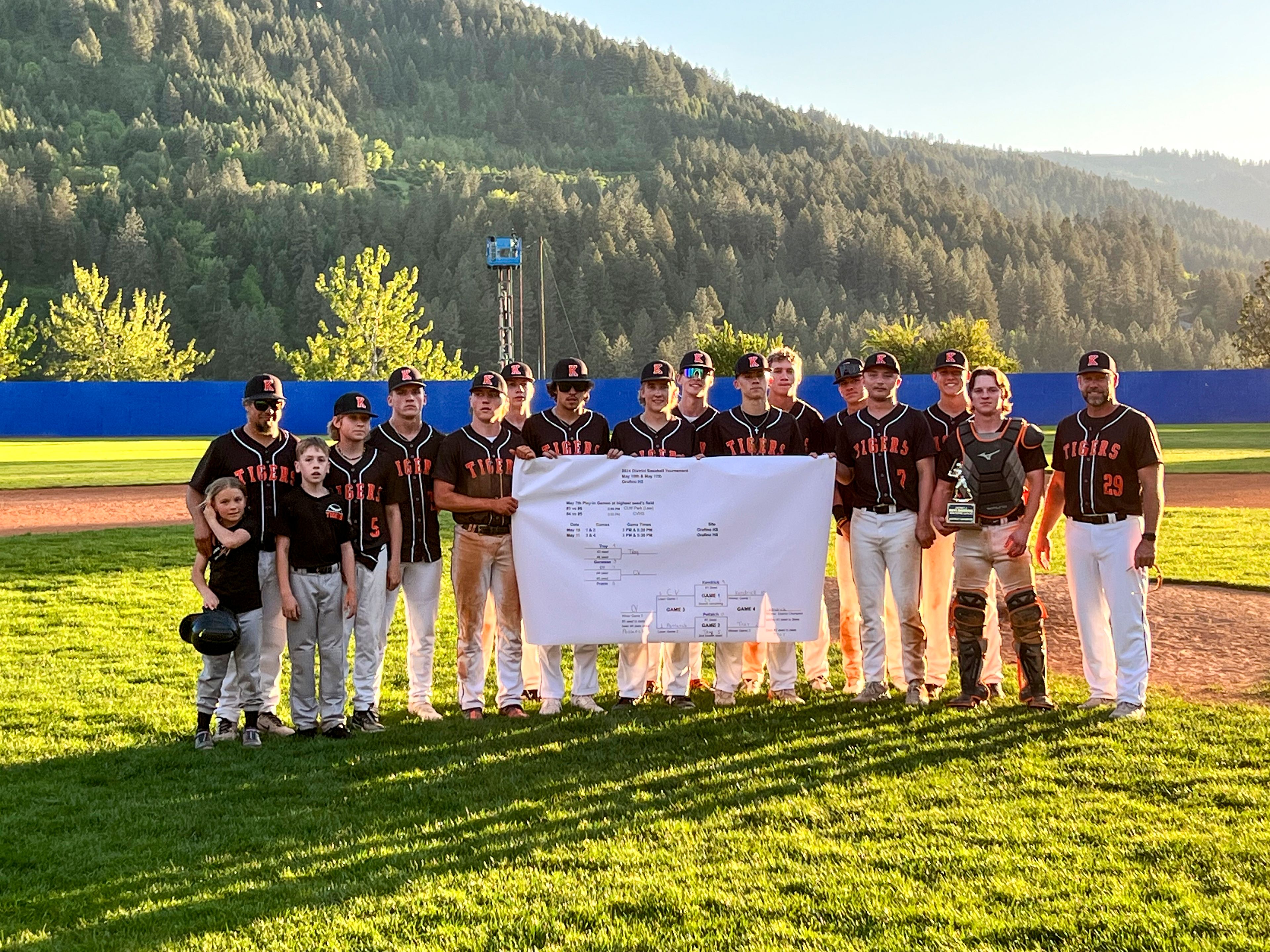 The Kendrick Tigers hold up the tournament bracket after defeating Troy in an Idaho Class 1A district championship game Saturday in Orofino.