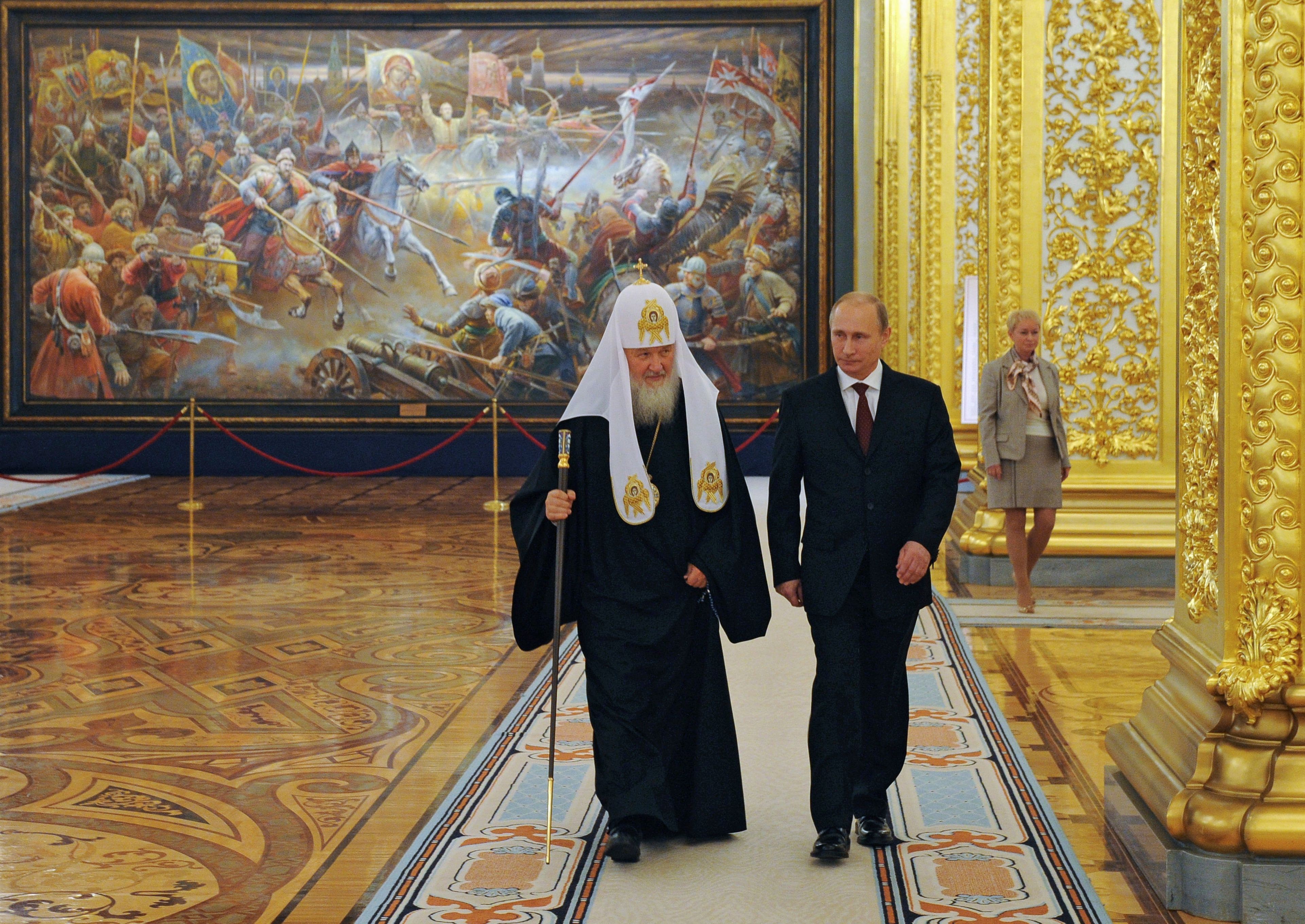 FILE - Russian President Vladimir Putin and Russian Orthodox Patriarch Kirill arrive to attend the gala reception marking the National Unity Day at the Kremlin in Moscow, Russia, Tuesday, Nov. 4, 2014. From the early years of his rule, Putin has repeatedly contended that studying Russian history should make Russians proud of their country. In Russia, history has long become a propaganda tool used to advance the Kremlin's political goals. (Mikhail Klimentyev, Sputnik, Kremlin Pool Photo via AP, File)