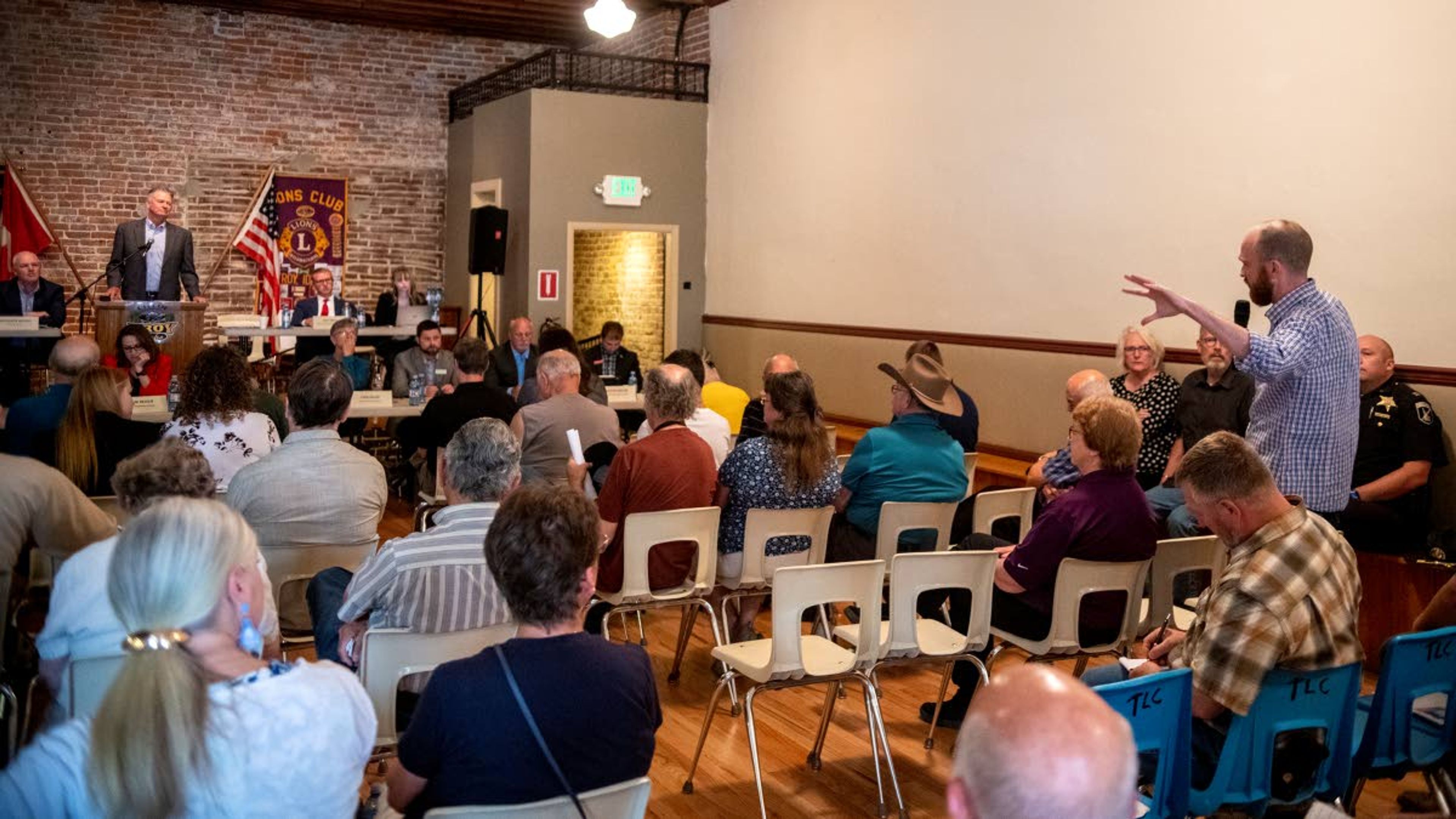 Jesse Sumpter, of Moscow, right, asks Idaho Gov. Brad Little about his handling of coronavirus in 2020 with regard to the first amendment and religious freedom during Little’s "Capital for a Day" tour at Troy’s Lion Club on Thursday morning.