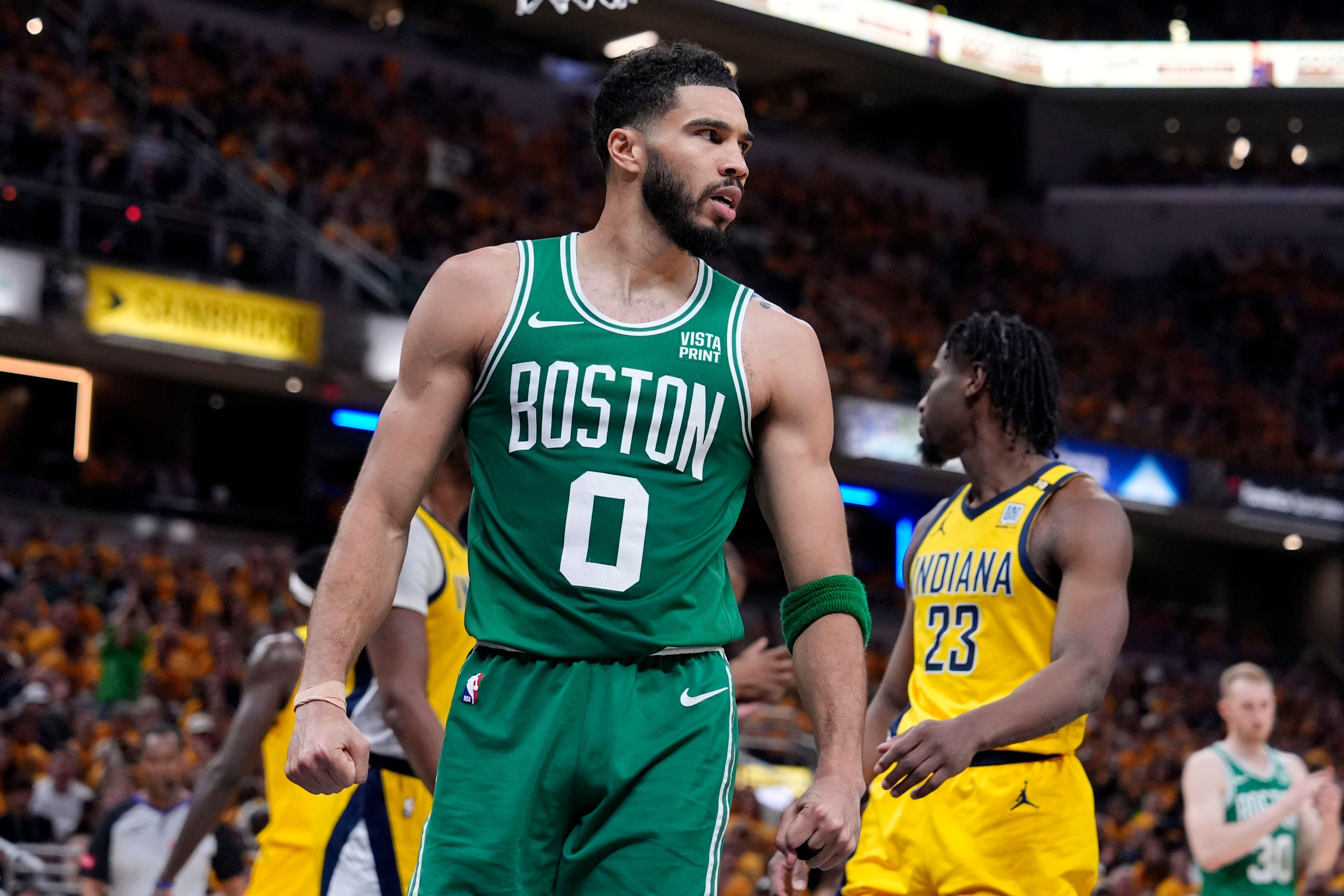 Boston Celtics forward Jayson Tatum (0) reacts after making a basket during the first half of Game 4 of the NBA Eastern Conference basketball finals against the Indiana Pacers, Monday, May 27, 2024, in Indianapolis. (AP Photo/Michael Conroy)