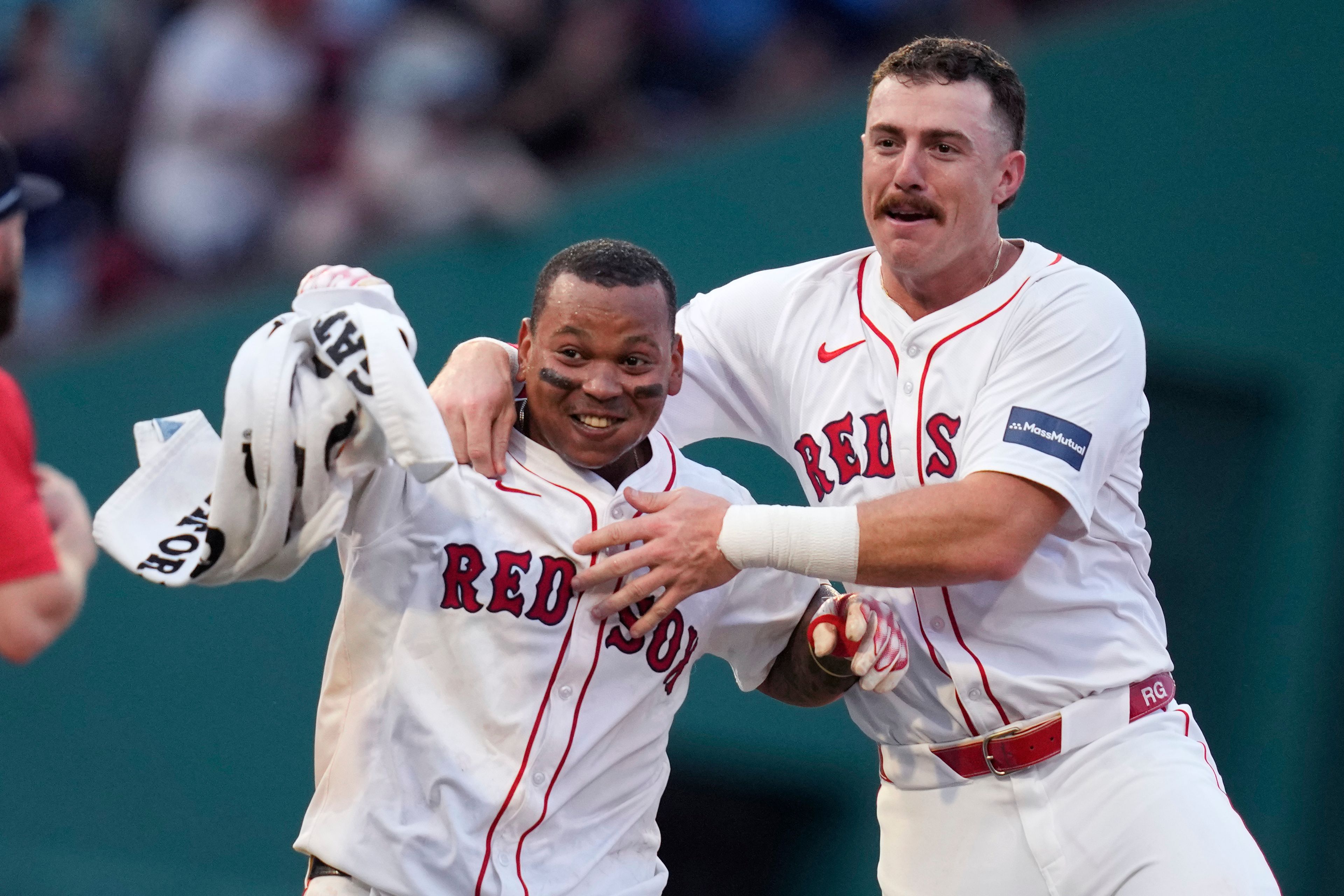 Boston Red Sox's Rafael Devers, left, celebrates after his game-winning RBI double, which drove in Tyler O'Neill, during the 10th inning of a baseball game against the Seattle Mariners, Wednesday, July 31, 2024, in Boston. At right is Boston Red Sox shortstop Romy Gonzalez. (AP Photo/Charles Krupa)