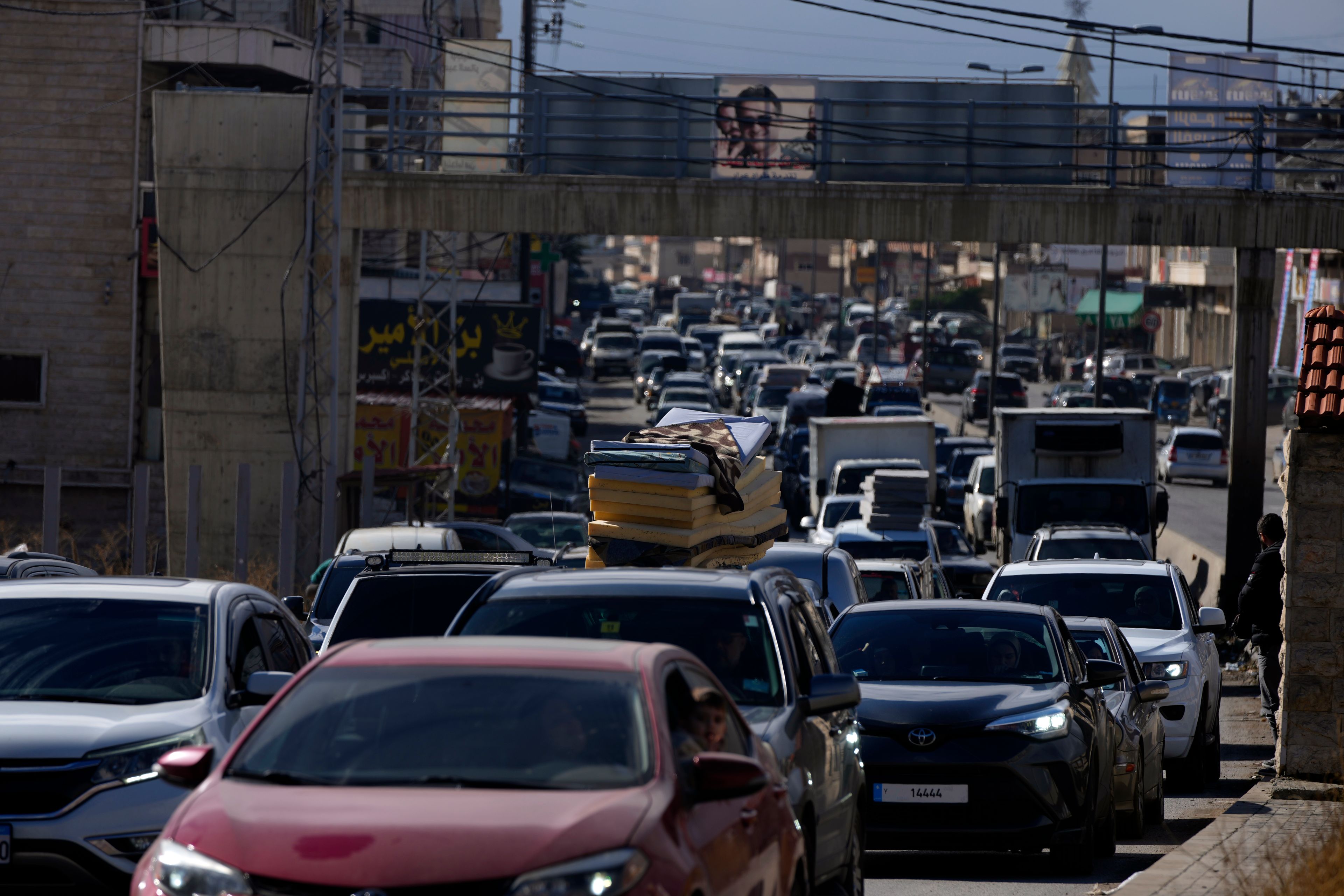 Displaced residents sit in traffic as they return to their villages following a ceasefire between Israel and Hezbollah that went into effect on Wednesday, Nov. 27, 2024, in Ablah, eastern Lebanon. (AP Photo/Hassan Ammar)