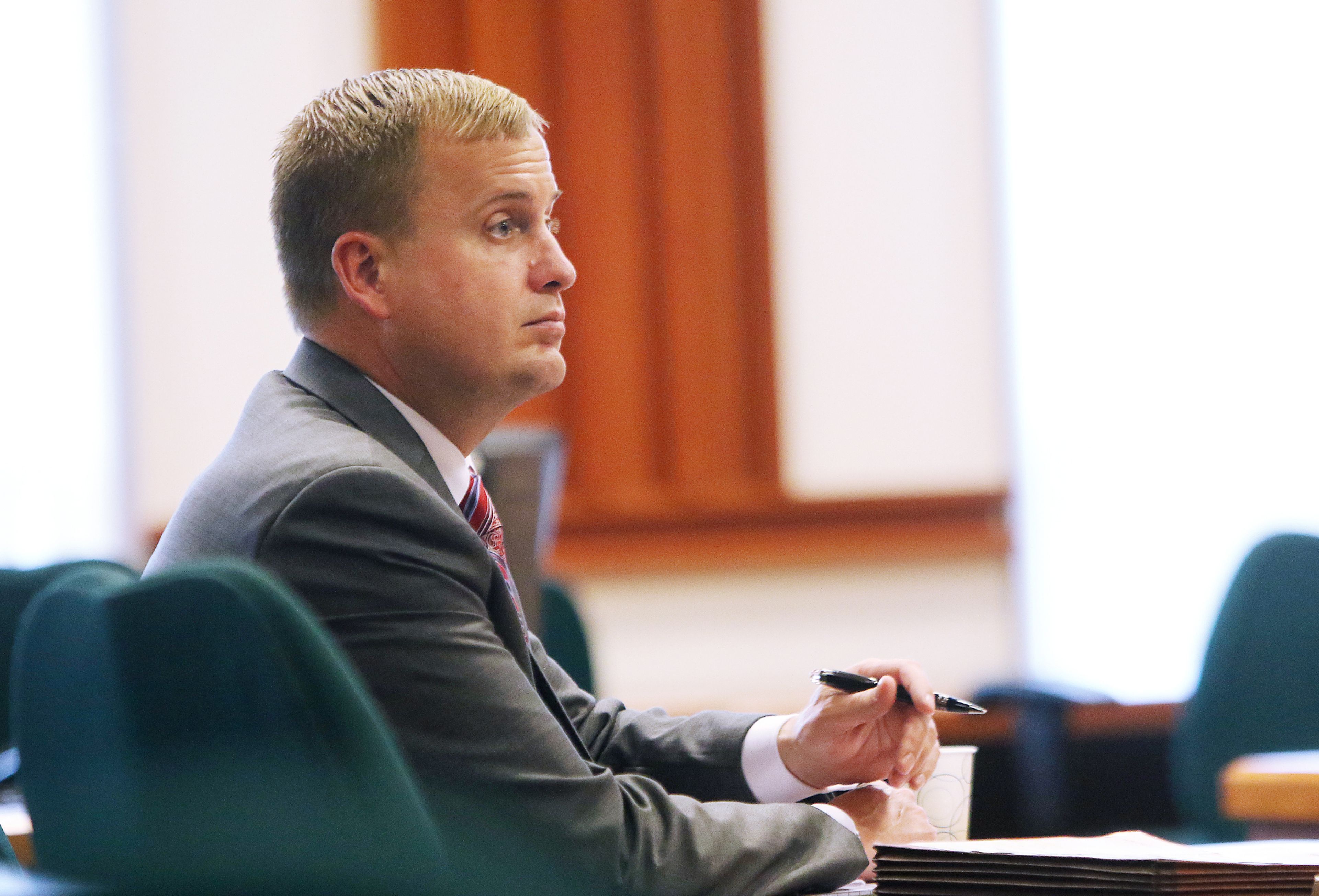 Former Idaho state Rep. Aaron von Ehlinger takes notes Tuesday during the opening day of testimony in his rape trial at the Ada County Courthouse in Boise.