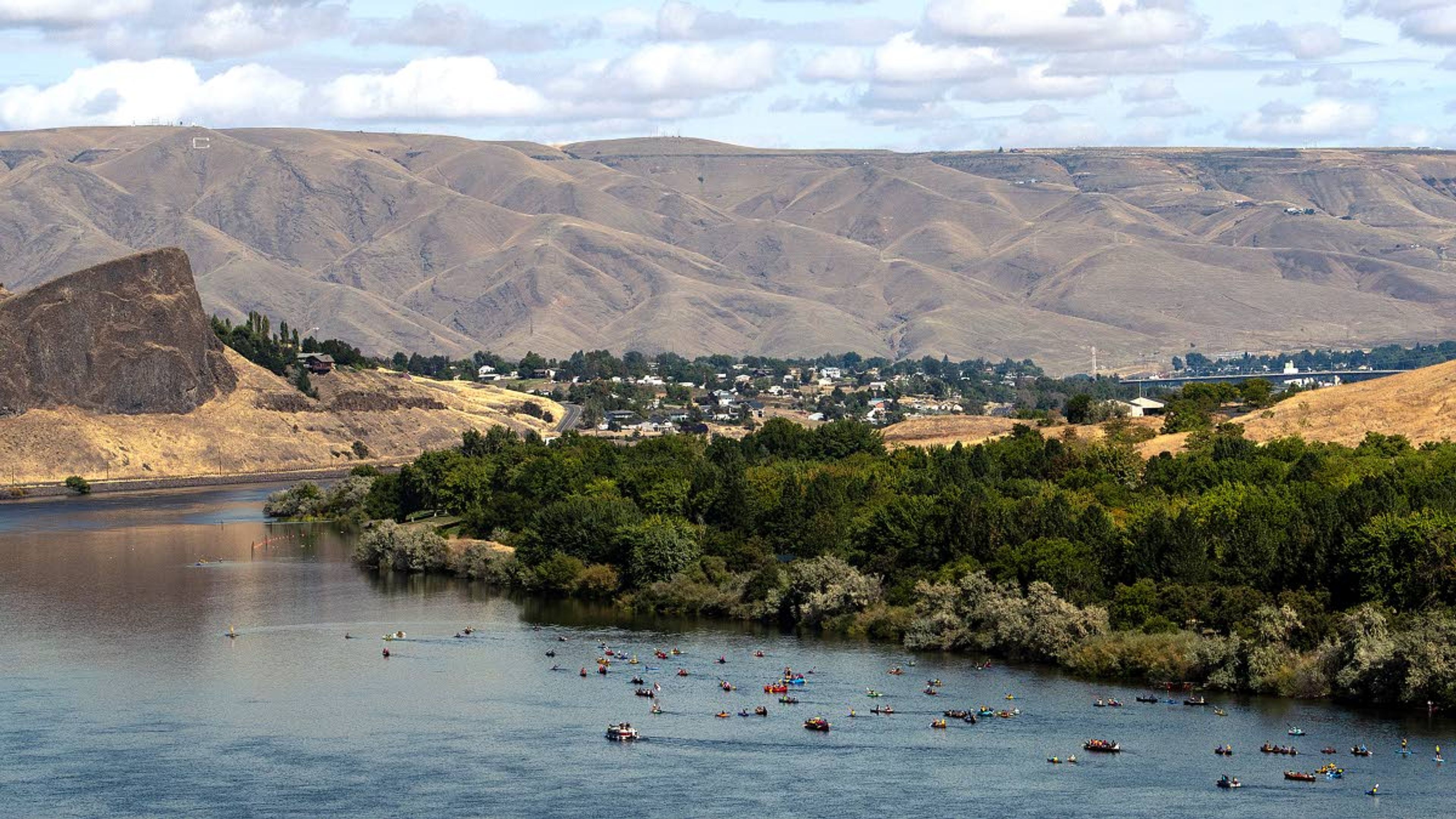 Paddles using kayaks, canoes and rafts make their way down the Snake River toward Hells Gate State Park during the Nimiipuu River Rendezvous on Saturday morning.