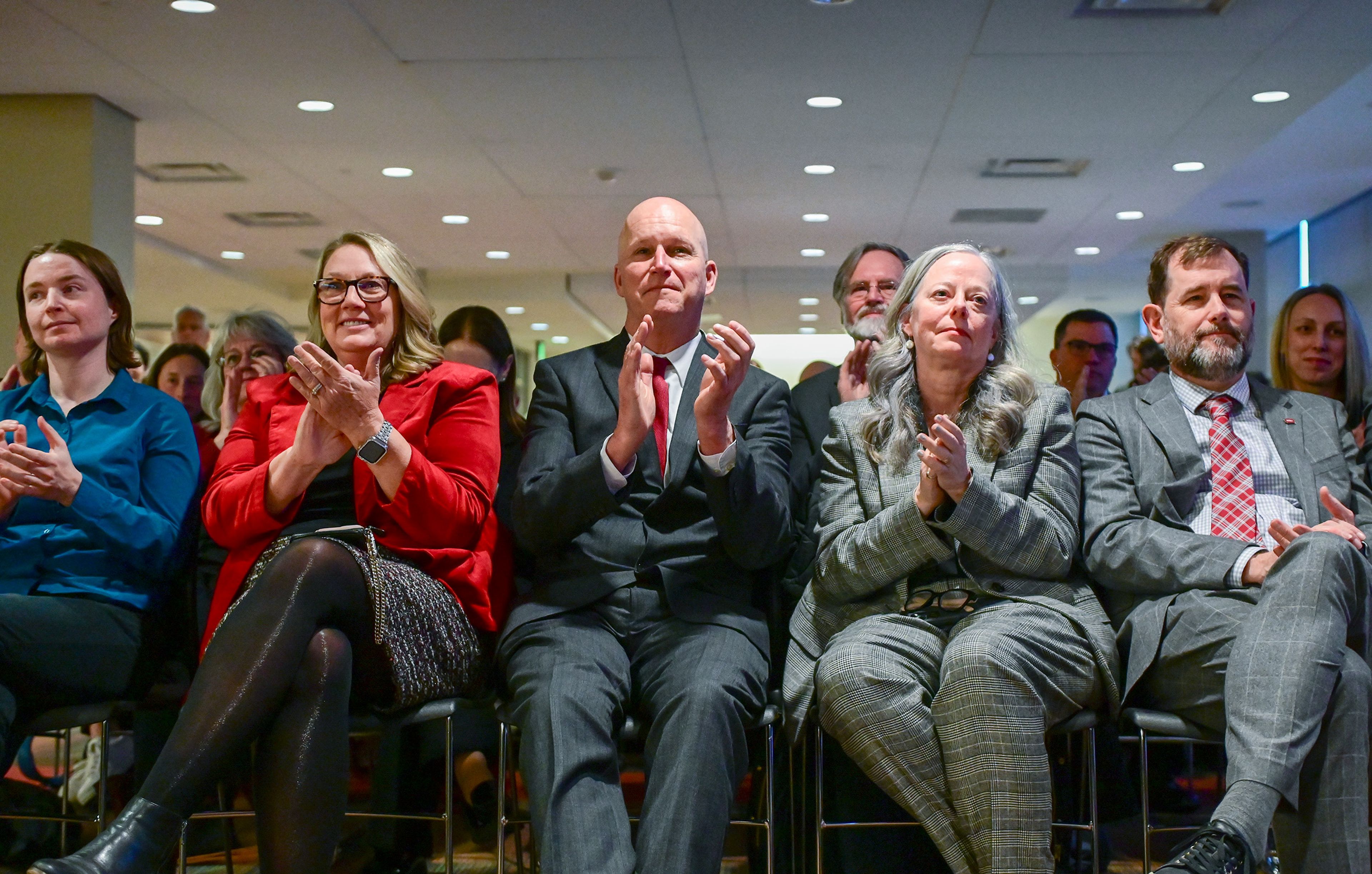 Those present at the Washington State University Board of Regents meeting Thursday clap for the introduction of Elizabeth “Betsy” Cantwell, not pictured, as the newly appointed WSU president in Pullman. The front row included Hannah Hallikainen, from left, Cantwell’s daughter and current graduate student at WSU, Pam Scott, Cantwell’s friend and former co-worker, Dave Cillay, WSU Pullman Chancellor, Leslie Brunelli, WSU executive vice president for finance and administration, and T. Chris Riley-Tillman, WSU provost and executive vice president.