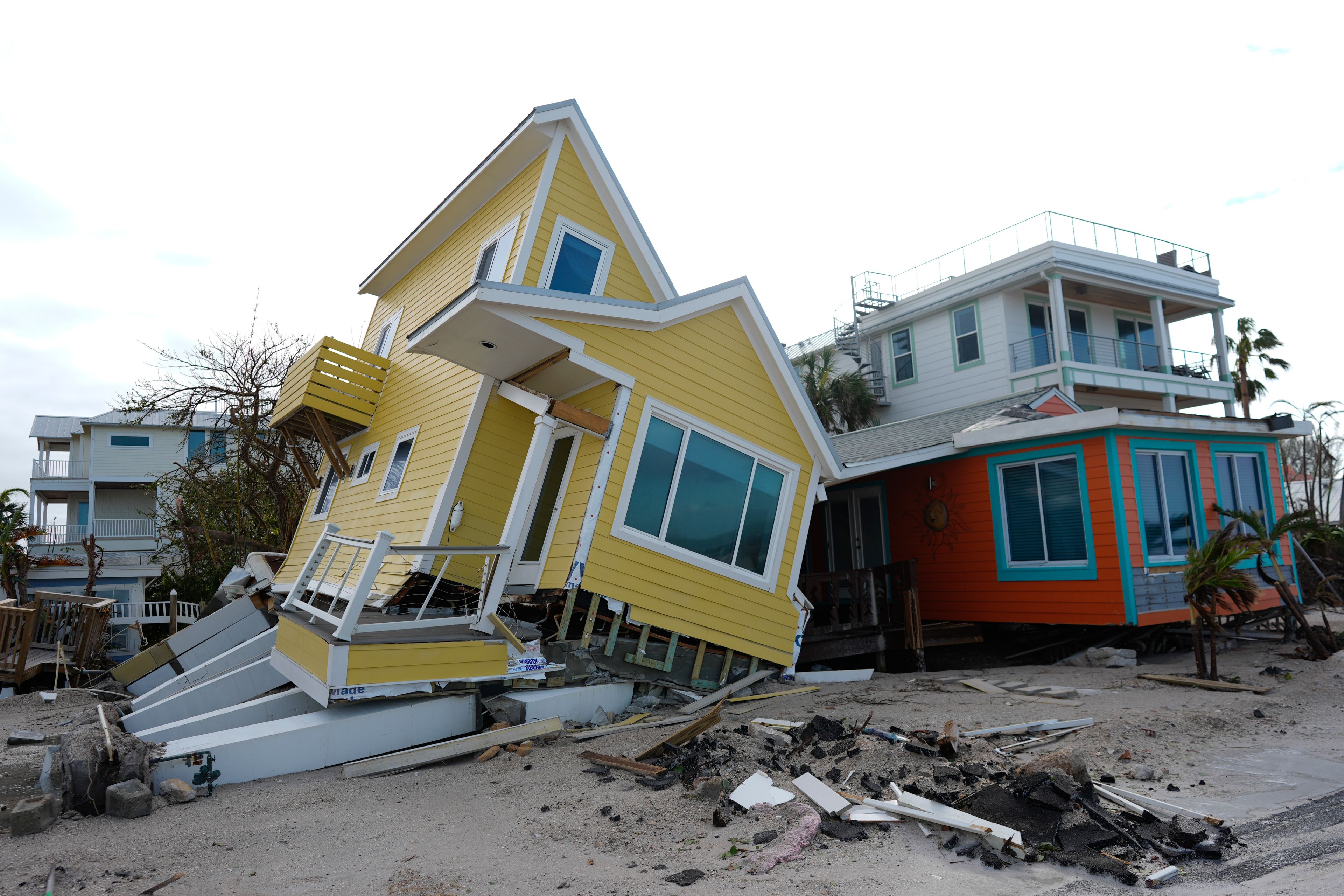 A house lies toppled off its stilts after the passage of Hurricane Milton, in Bradenton Beach on Anna Maria Island, Fla., Thursday, Oct. 10, 2024. (AP Photo/Rebecca Blackwell)