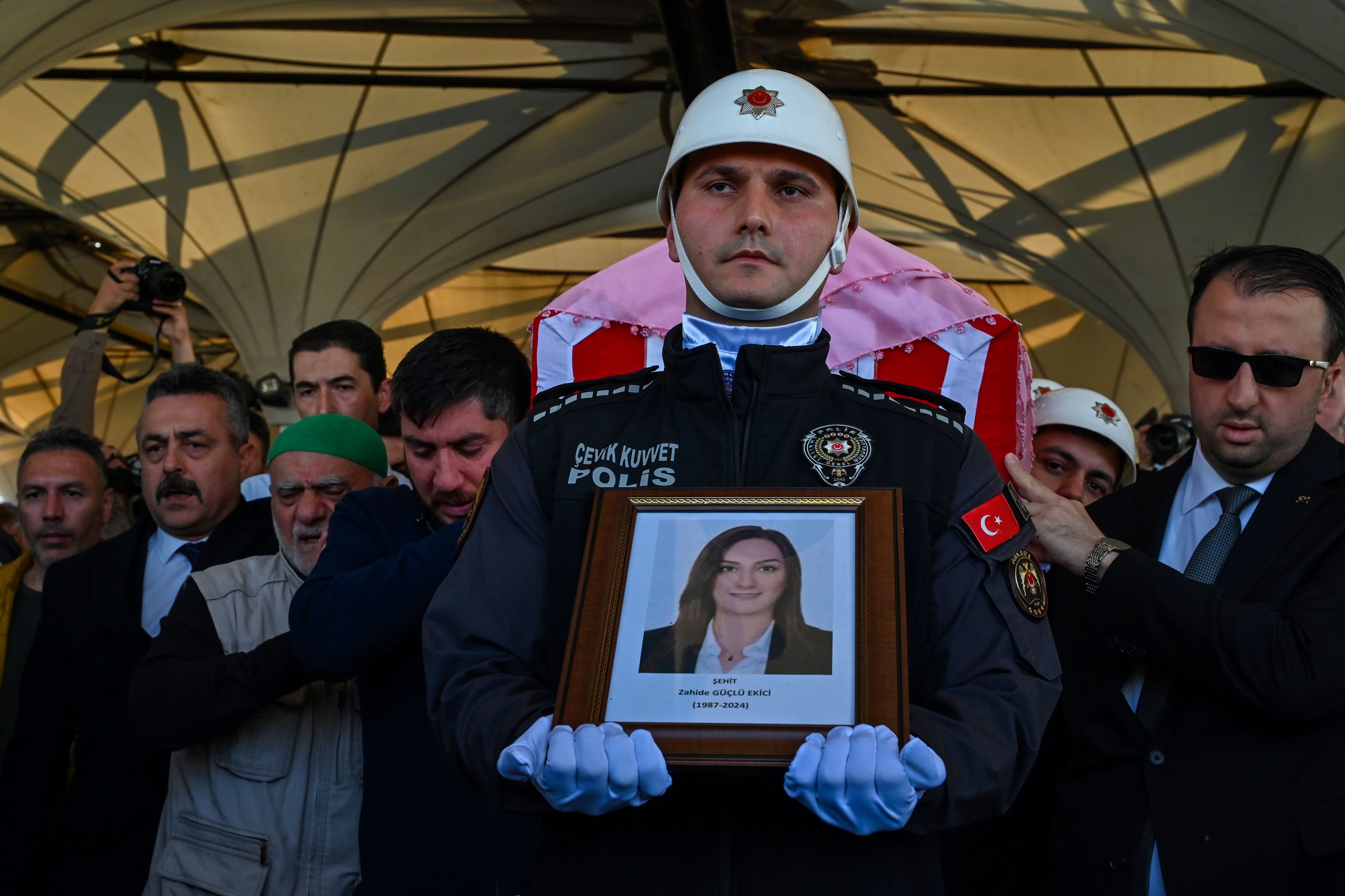 Relatives and Turkish soldiers carry the coffin of Zahide Guglu Ekici, who was killed during an attack by PKK members at the Turkish aerospace and defense company TUSAS in Ankara on Wednesday, during a funeral at Karsiyaka mosque in Ankara, Thursday, Oct. 24, 2024. (AP Photo/Ali Unal)