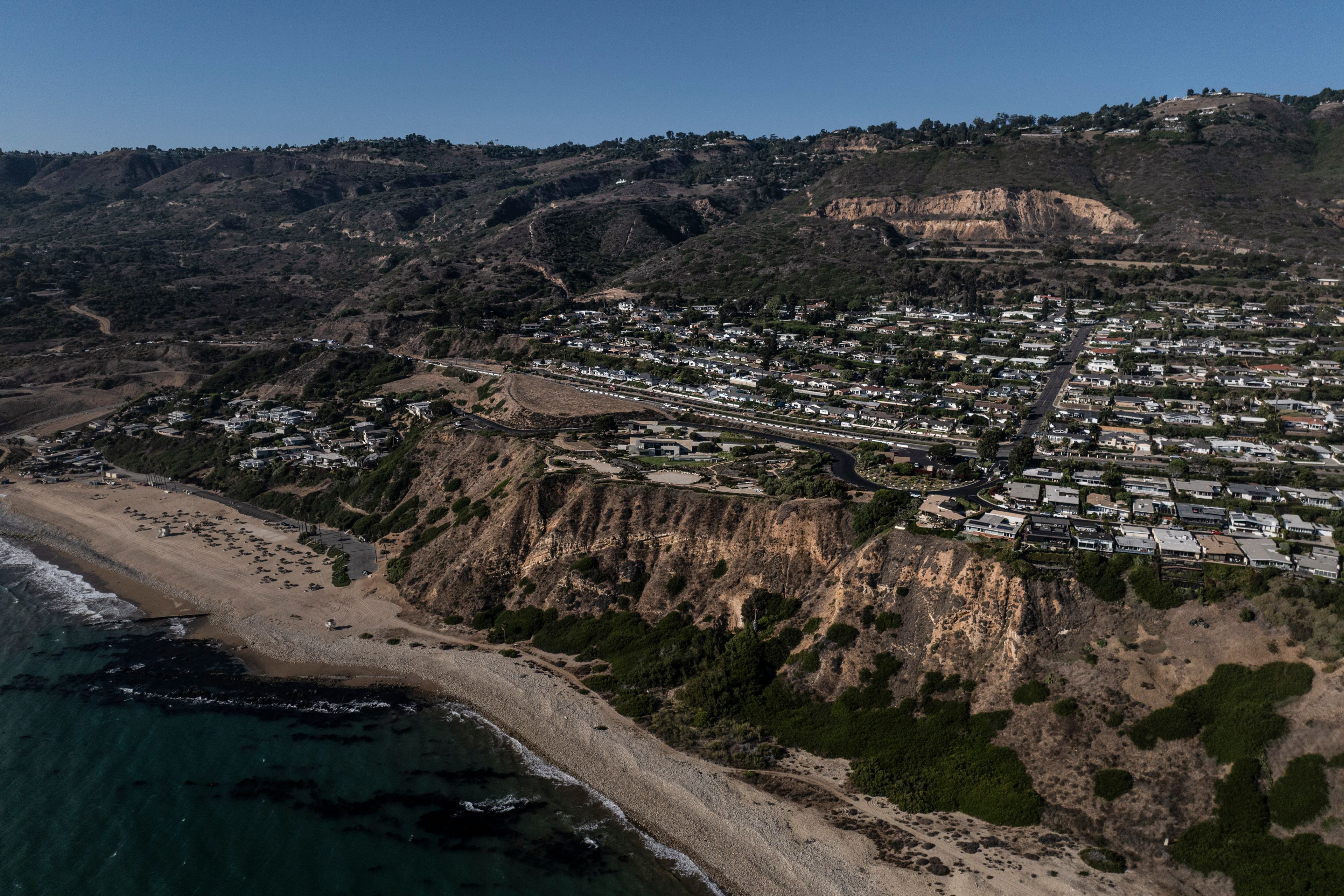 An aerial view shows a neighborhood affected by ongoing landslides in Rancho Palos Verdes, Calif., Tuesday, Sept. 3, 2024.