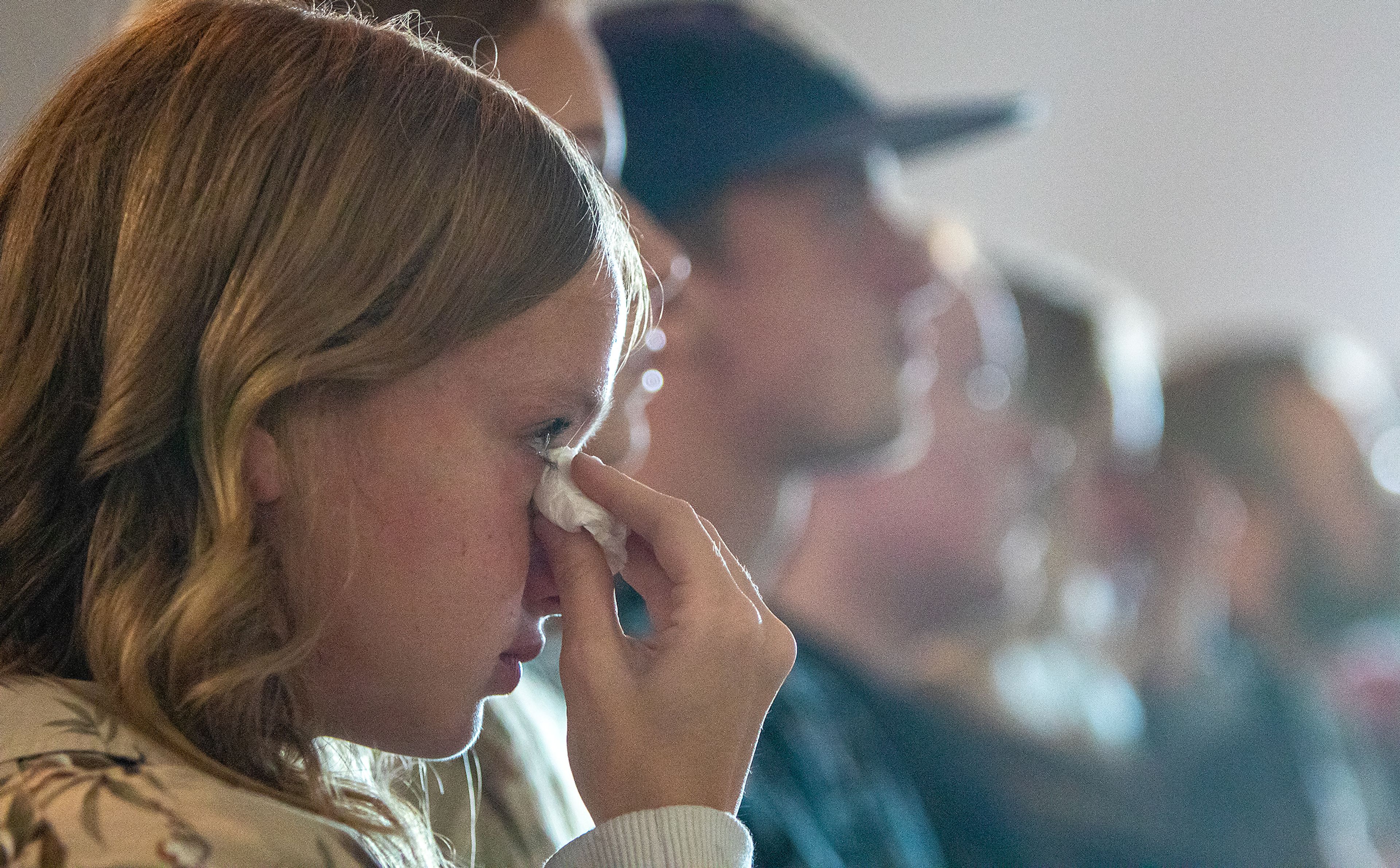 Wayne Hirschel’s granddaughter Chloe Curry, sheds a tears Saturday at her grandfather’s memorial in the Bennett Building of the Asotin County Fairgrounds in Asotin.