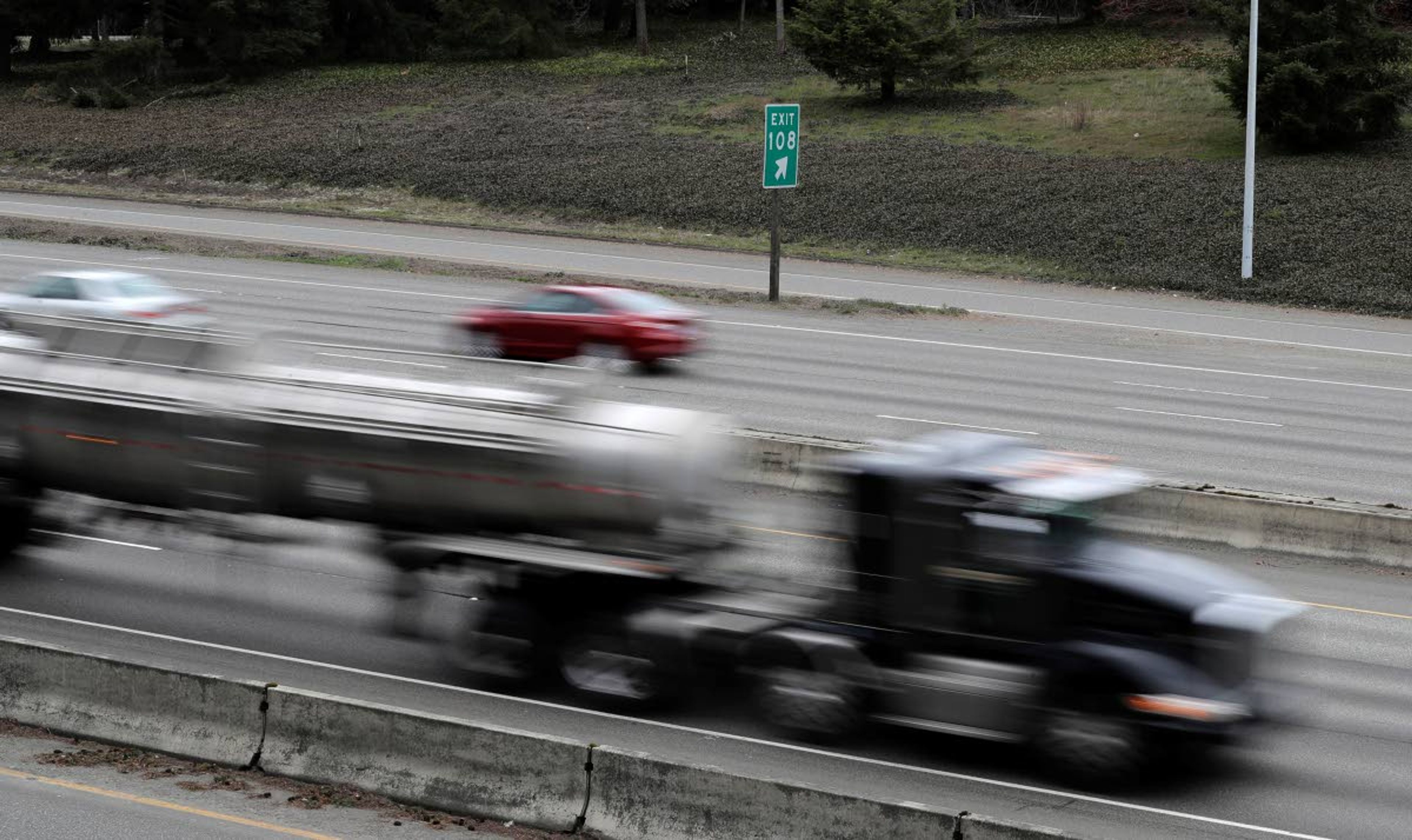 Cars and trucks travel on Interstate Highway 5 near Olympia, Wash., Monday, March 25, 2019. Democrats in the Washington House released their two-year transportation budget proposal Monday, which includes $9.9 billion in spending for projects. (AP Photo/Ted S. Warren)