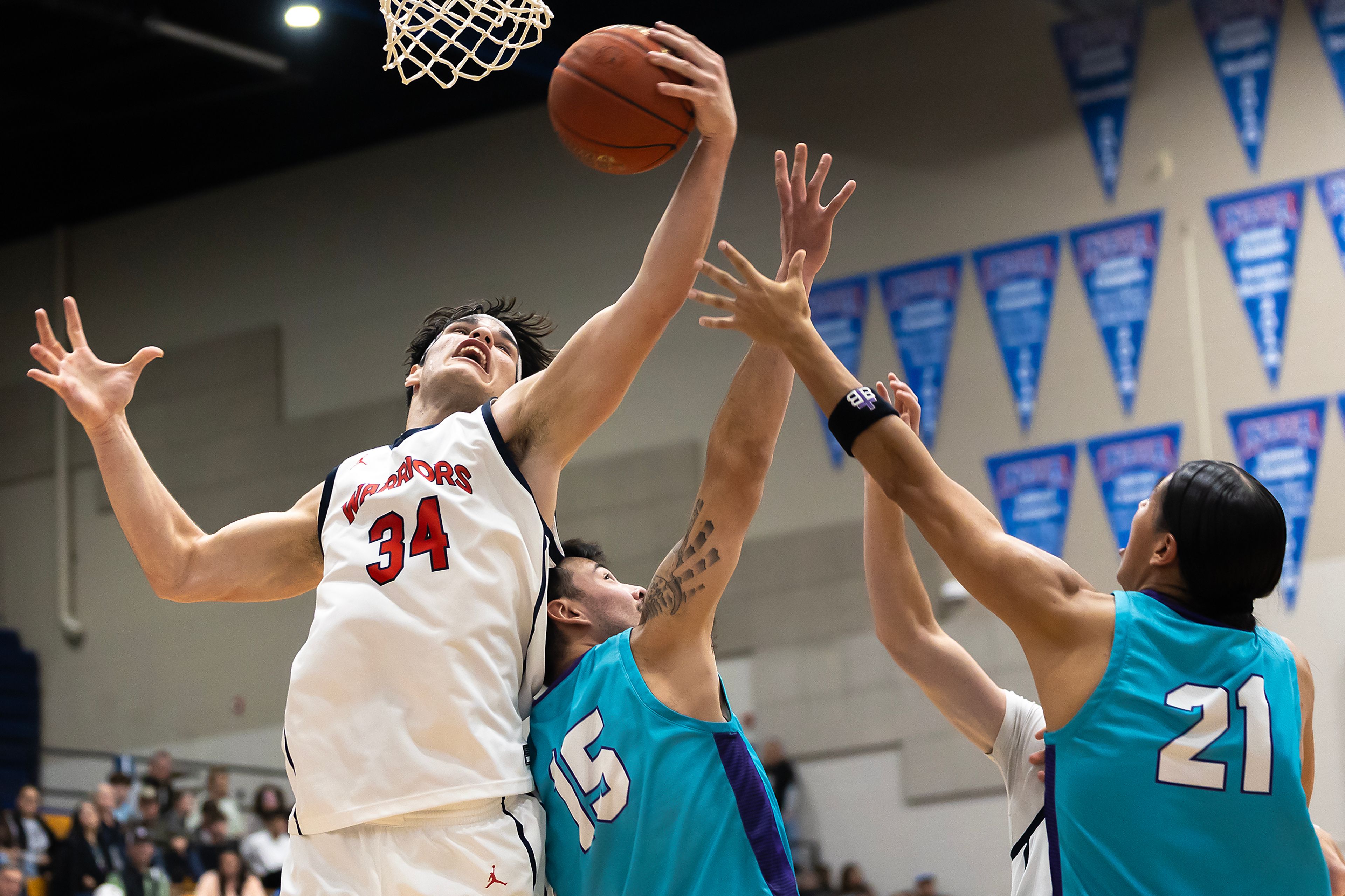 Lewis-Clark State forward Josh Salguero grabs the rebound away from Haskell�s Damian White (15) and Alexander Ellenwood during the season opening game as part of Tribal Nations Weekend Saturday in Lewiston.,