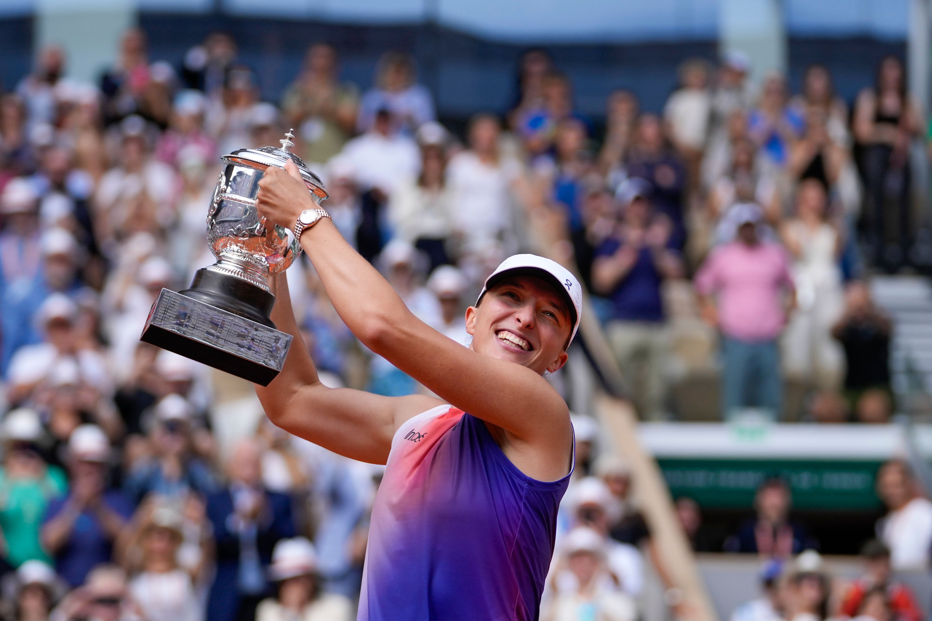 Poland's Iga Swiatek holds the trophy after winning the women's final of the French Open tennis tournament against Italy's Jasmine Paolini at the Roland Garros stadium in Paris, France, Saturday, June 8, 2024.