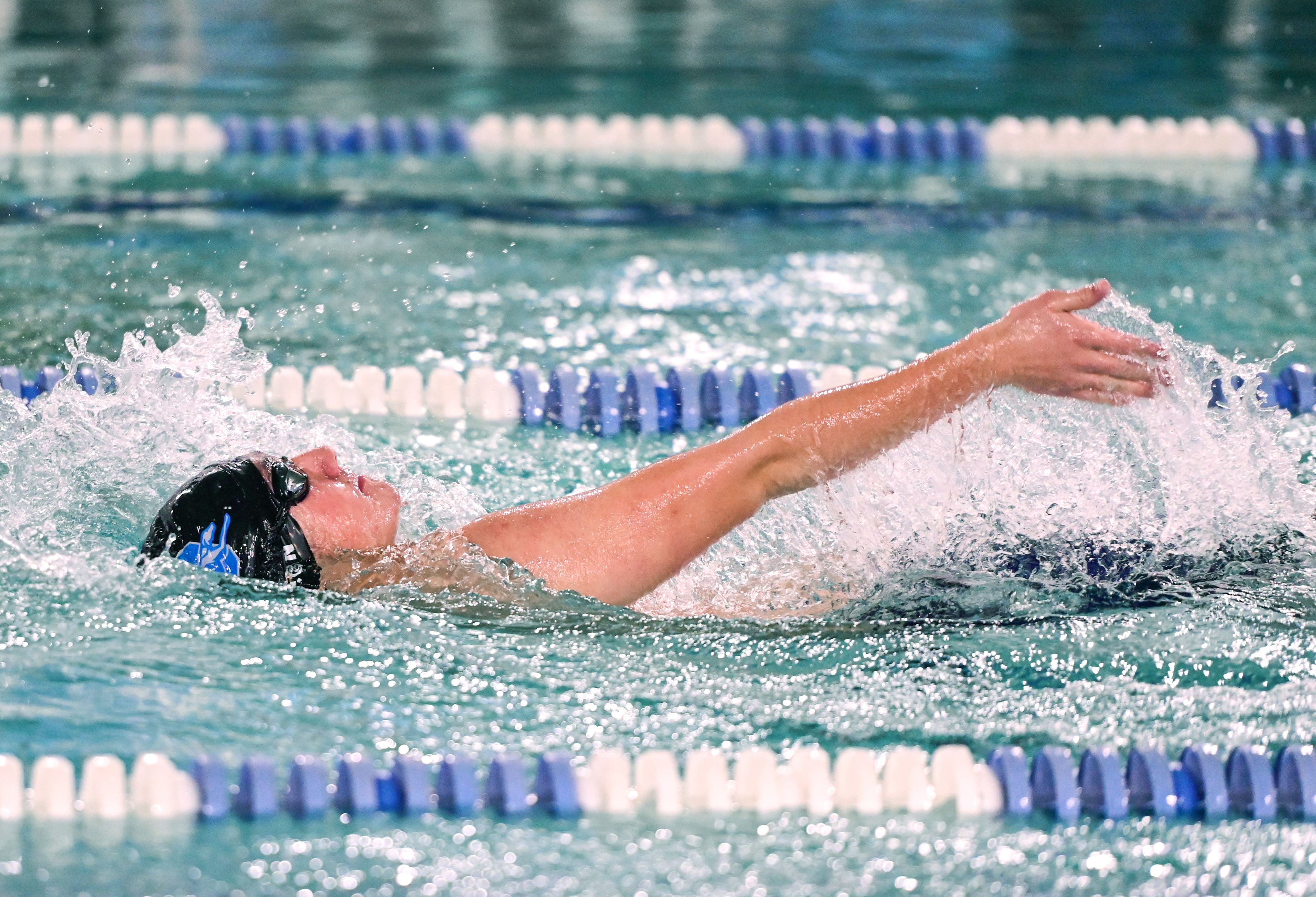 Pullman freshman Liam Rhoden races in the 100-yard backstroke at a meet with Moses Lake in Pullman on Tuesday.