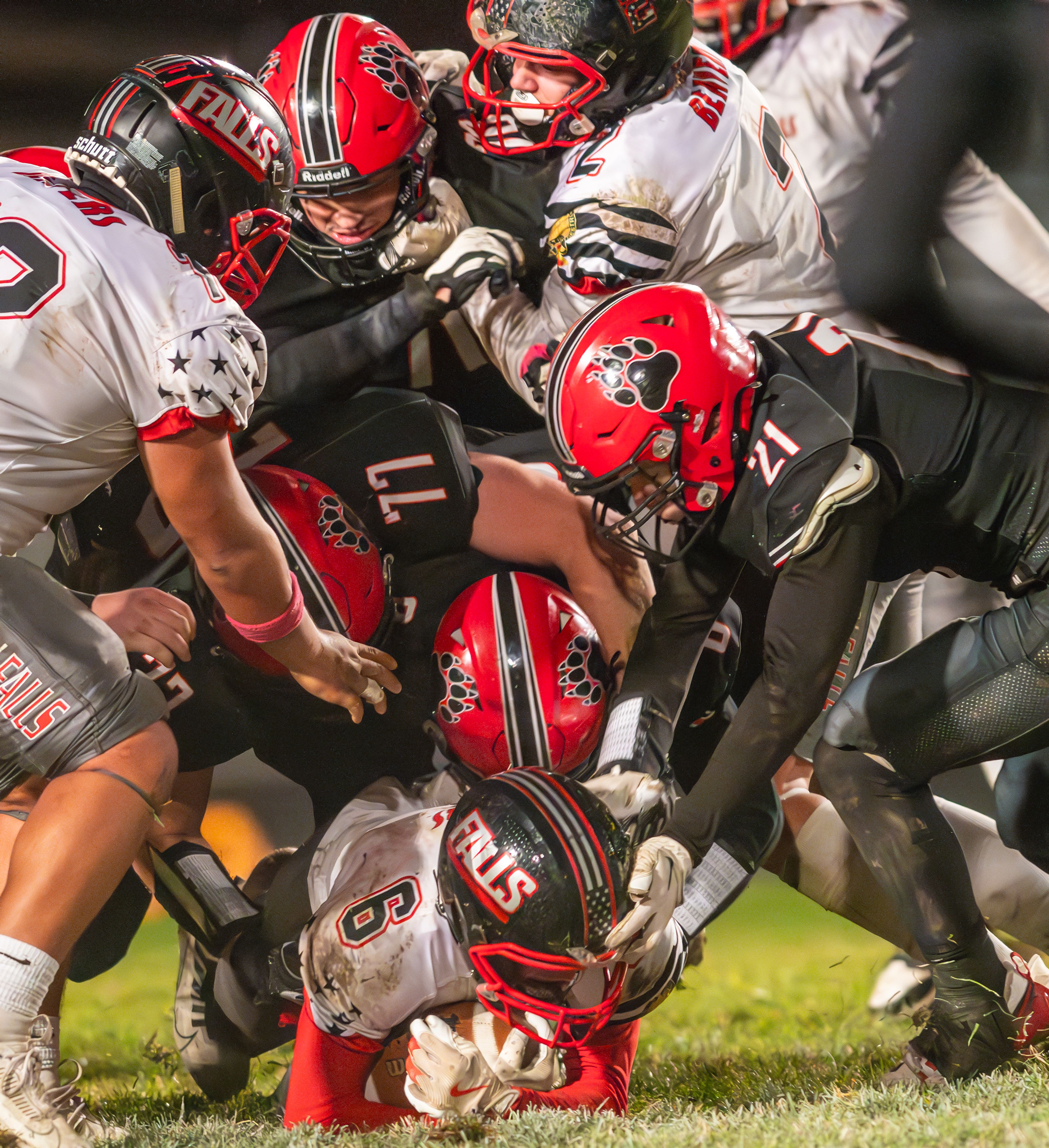 American Falls' Zak Grigg is brought down by multiple Moscow players during an Idaho 4A playoff game Friday in Moscow.