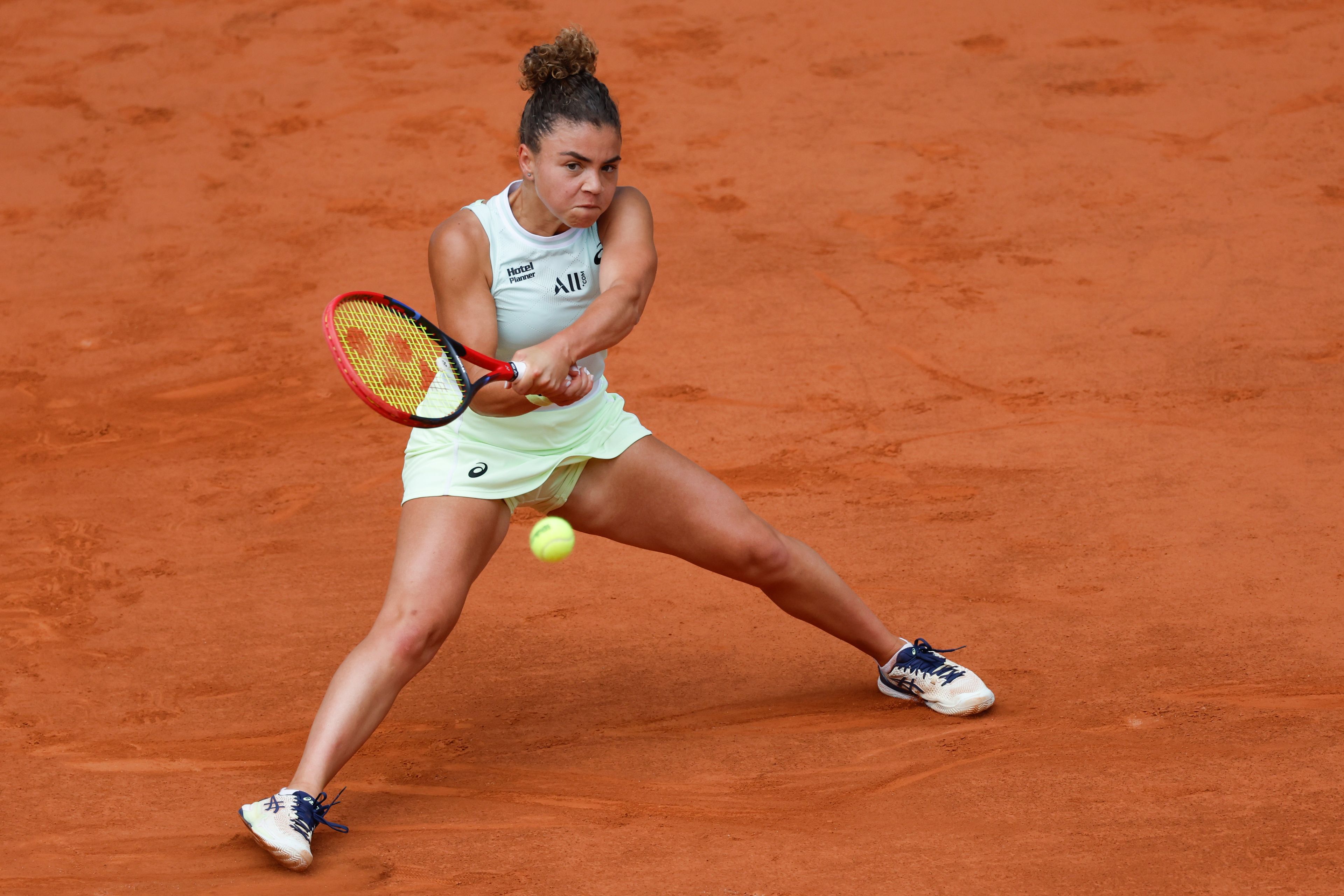 Italy's Jasmine Paolini plays a shot against Poland's Iga Swiatek during the women's final of the French Open tennis tournament at the Roland Garros stadium in Paris, France, Saturday, June 8, 2024.