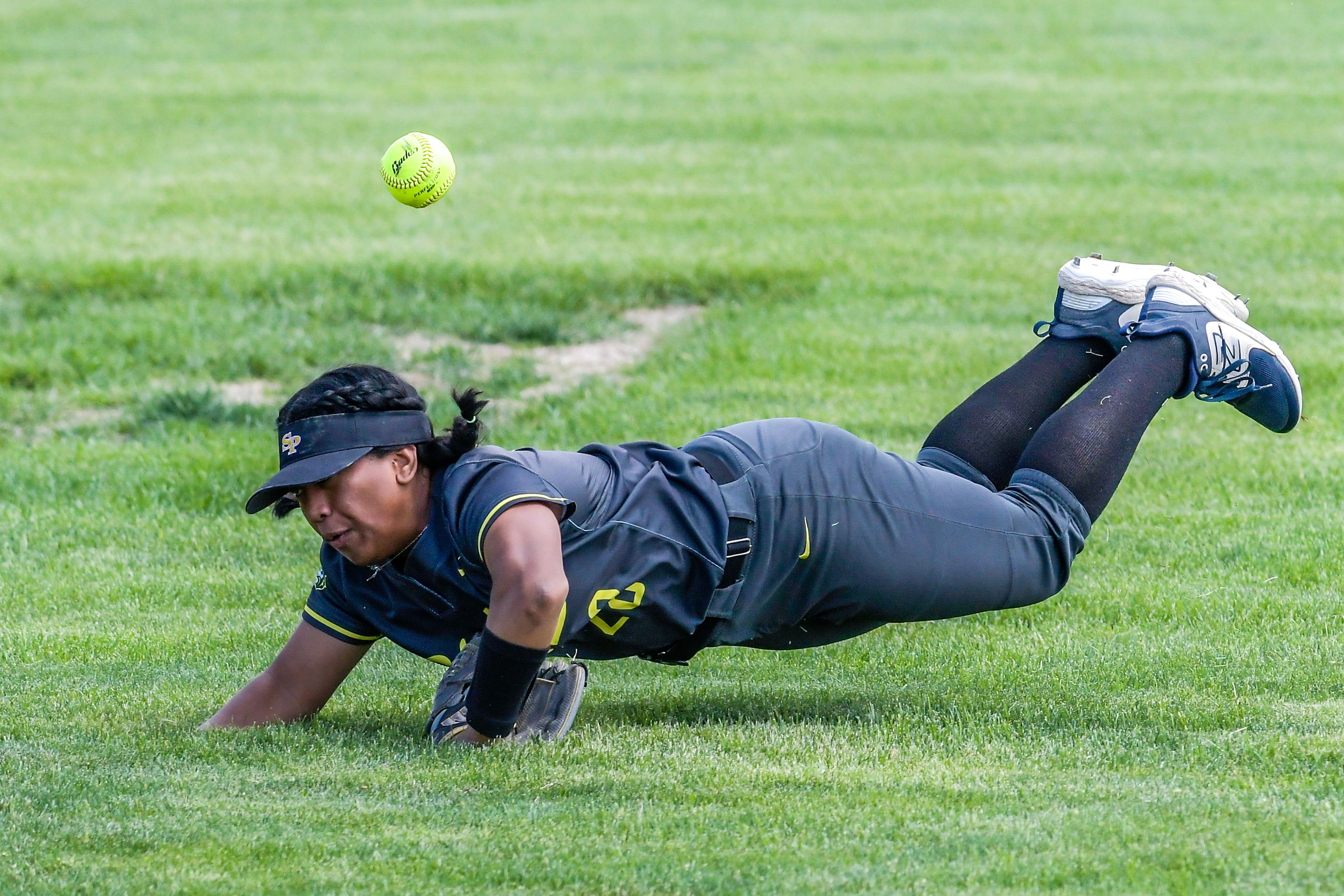 Shadle Park center fielder Bethany Rinas attempts to make a catch on a Clarkston hit during an inning of the District Championship Game Saturday in Clarkston.