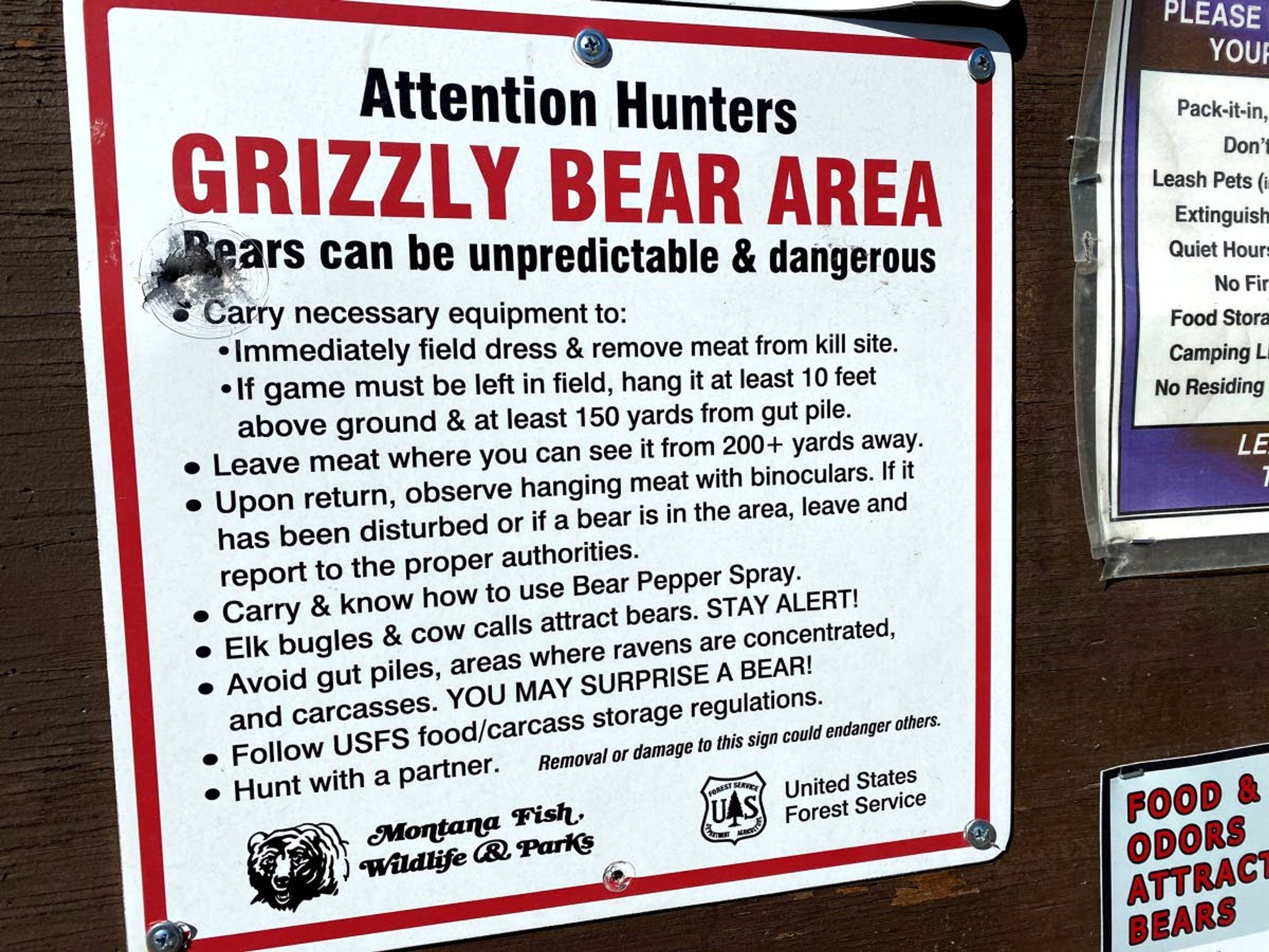 A sign at a trailhead warns hunters to take precautions in grizzly bear country.