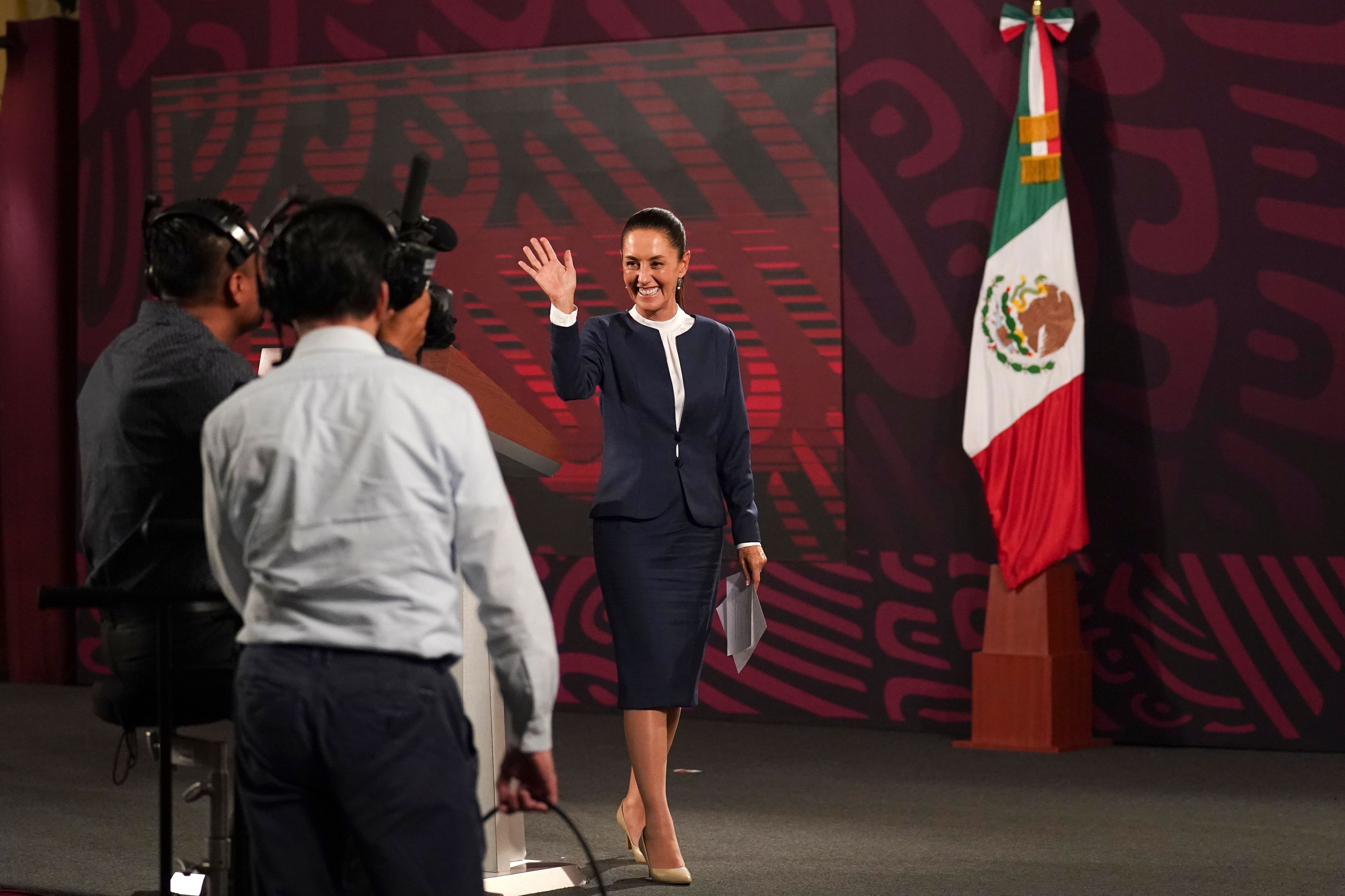 FILE - President-elect Claudia Sheinbaum waves after attending the early morning daily press briefing, at the National Palace, in Mexico City, June 10, 2024. Sheinbaum, a climate scientist and former Mexico City mayor, will be sworn in as Mexicoâ€™s first woman president on Oct. 1. (AP Photo/Marco Ugarte, File)